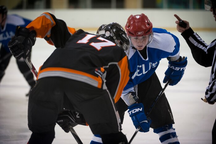 Senior Airman Camren Rizzo (blue jersey), a forward on the Nellis Air Force Base hockey team, prepares to faceoff with a member of the Desert Foxes hockey team in Las Vegas Sept. 10, 2014. Rizzo led the Nellis team to a season-opening victory over the Desert Foxes with a total of four goals scored. Rizzo is an Air Force Reservist assigned to the 926th Group Security Forces Squadron. (U.S. Air Force photo by Staff Sgt. Siuta B. Ika)