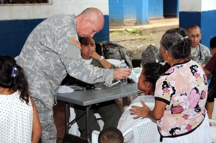 U.S. Army 1st Lt. William Trammel, a MEDEL registered nurse, takes the temperature of a child from La Poza, El Salvador.  JTF-Bravo's Medical Element, in conjunction with the 1-228th Aviation Regiment, U.S. Embassy in San Salvador, the El Salvador Ministry of Health and El Salvador military, conducted a medical readiness training exercise (MEDRETE) in La Poza, Department of Usulután, El Salvador, September 8-11 where over 1,250 people received medical care.  (Photo by U.S. Air National Guard Capt. Steven Stubbs)