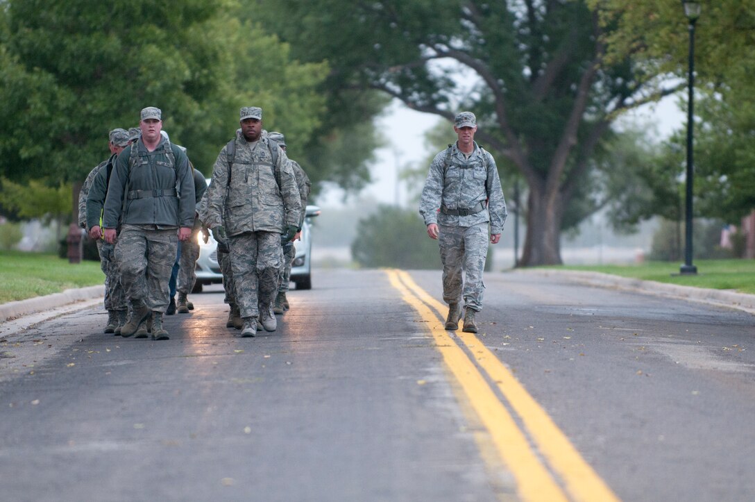 Ninetieth Logistics Readiness Squadron Airmen conduct a ruck march along the streets of F.E. Warren Air Force Base, Wyo., Sept. 11, 2014. The Airmen marched in remembrance of the Sept. 11 attacks against the U.S. and to honor F.E. Warren's first responders on the 13th anniversary of the attacks. (U.S. Air Force photo by Lan Kim)