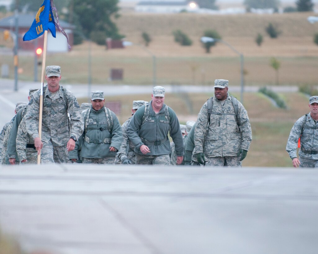 Ninetieth Logistics Readiness Squadron Airmen conduct a ruck march along the streets of F.E. Warren Air Force Base, Wyo., Sept. 11, 2014. The Airmen marched in remembrance of the Sept. 11 attacks against the U.S. and to honor F.E. Warren's first responders on the 13th anniversary of the attacks. (U.S. Air Force photo by Lan Kim)