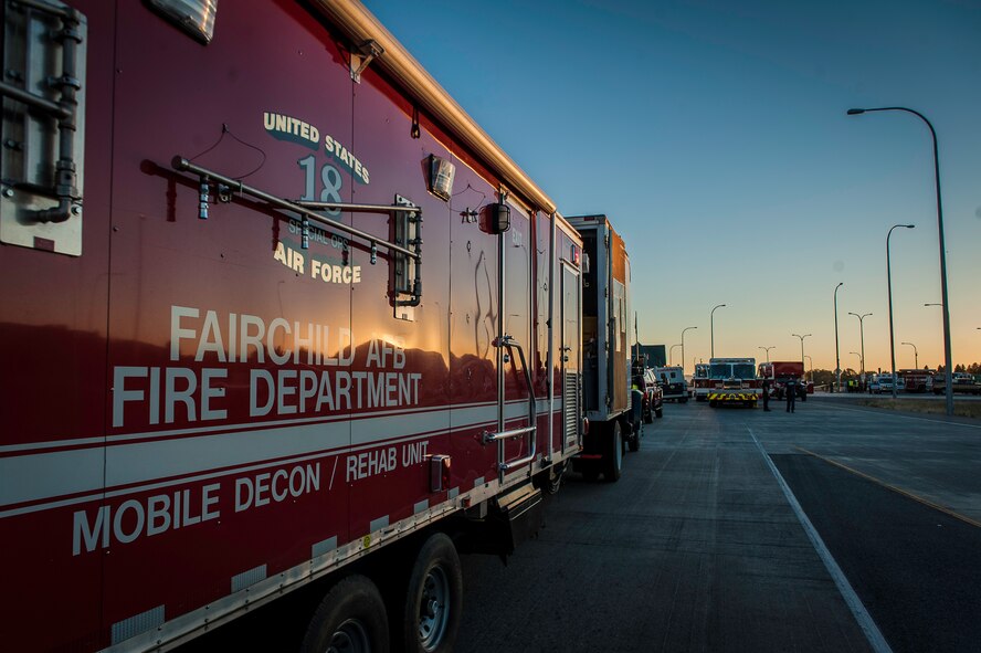 Fairchild Air Force Base firefighters responded with other regional firefighters to a hazardous materials spill incident where they performed decontamination, mitigation and rehabilitation support near the Washington-Idaho state line Sept. 14, 2014. Four Fairchild Air Force Base firefighters, one technician and a variety of support staff as well as the base’s mobile decontamination and rehabilitation unit joined two dozen other firefighters, trucks and equipment from Spokane regional fire districts in response to a tanker truck leaking anhydrous trimethylamine. The incident prompted emergency responders to shut down a 6-mile section of Interstate 90. The toxic leaked substance is a flammable material used in making solvents, animal feed supplements and products consumed by the paper, oil and gas industries. (U.S. Air Force photo/Staff Sgt. Benjamin W. Stratton)