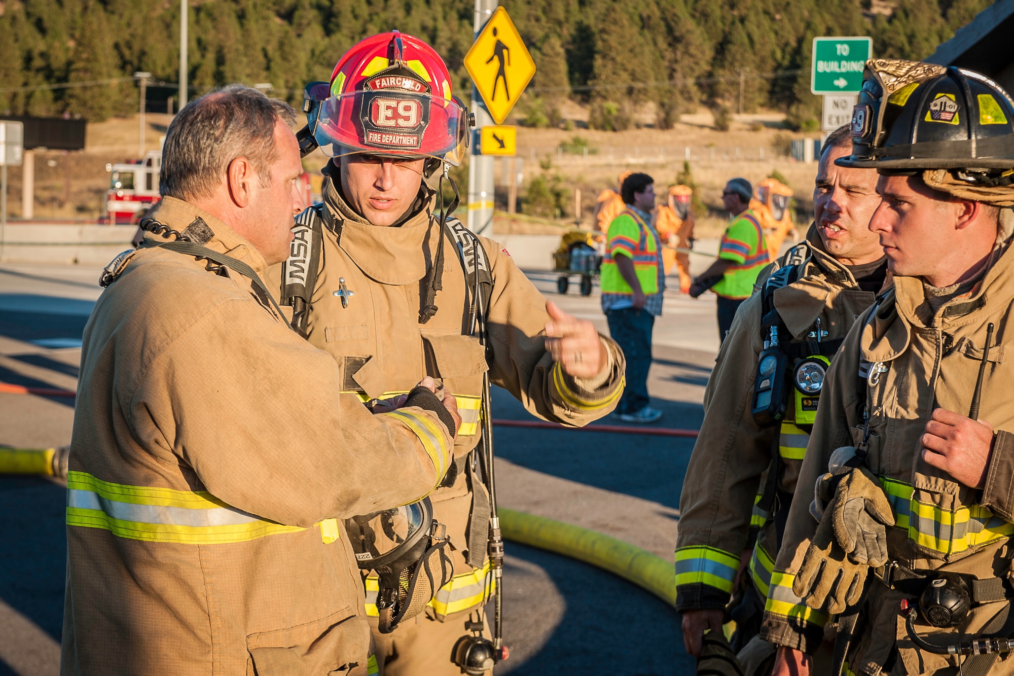 Fairchild Air Force Base firefighters join other regional firefighters near the spill zone of a hazardous materials incident as they prepare to perform decontamination support near the Washington-Idaho state line Sept. 14, 2014. A tanker truck leaking anhydrous trimethylamine, a flammable substance used in making solvents, animal feed supplements and products consumed by the paper, oil and gas industries, prompted emergency responders to shut down Interstate 90 garnering immense regional response including Fairchild Air Force Base firefighters. (U.S. Air Force photo by Staff Sgt. Benjamin W. Stratton/Released)