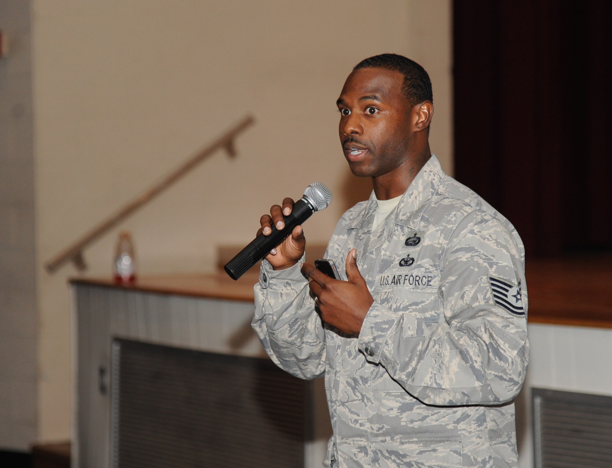 Tech. Sgt. Glenn Davis, 335th Training Squadron, delivers closing remarks to Keesler Airmen during an Airmen Building Airmen program, which he created and organized, Sept. 12, 2014, at the Welch Theater, Keesler Air Force Base, Miss.  The goal of the symposium was to create a platform where outstanding Airmen can impart their wisdom to the next generation of Airmen.  The event included guest speakers and a social mixer. (U.S. Air Force photo by Kemberly Groue)