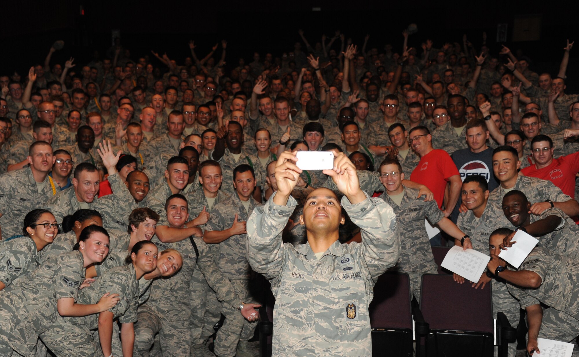 Tech. Sgt. Jewell Hicks, inspector/operations, Lackland Air Force Base, Texas, takes a selfie with Keesler Airmen during an Airmen Building Airmen program Sept. 12, 2014, at the Welch Theater, Keesler Air Force Base, Miss.  The goal of the symposium was to create a platform where outstanding Airmen can impart their wisdom to the next generation of Airmen.  The event included other guest speakers and a social mixer. (U.S. Air Force photo by Kemberly Groue)