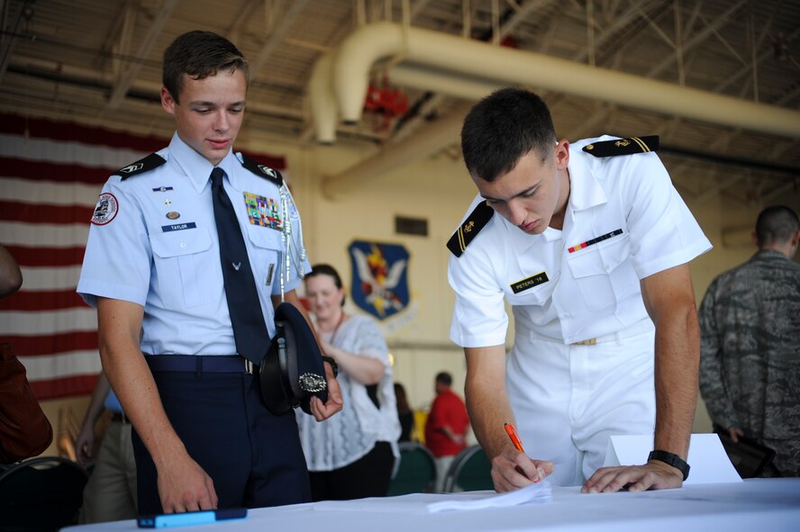 U.S. Naval Academy Midshipman 2nd Class Samuel Peters writes down contact information for Lowndes County High School senior, Logan Taylor, during the 2014 Military Service Academy Day Sept. 13, at Moody Air Force Base, Ga. Taylor attended the event to gain insight into the admission processes for the five U.S. Military Academies. (U.S. Air Force photo by Andrea Jenkins)
