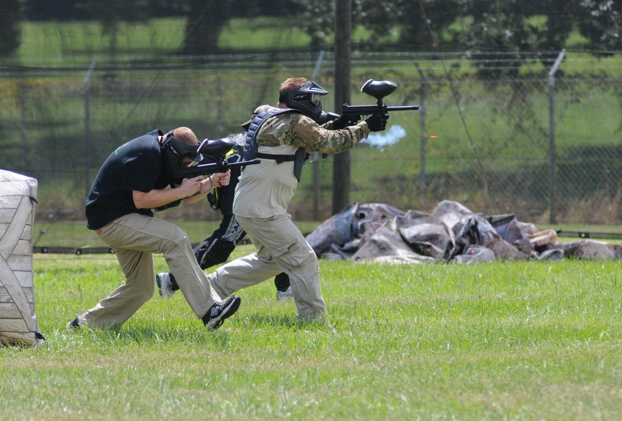 Master Sgts. Brian Lamar and Wesley Brantley, 403rd Wing, make their way across the field during the Fisher House Fundraiser paintball tournament Sept. 12, 2014, at the paintball complex, Keesler Air Force Base, Miss.  The event also included food, games and a dunking booth. (U.S. Air Force photo by Kemberly Groue)