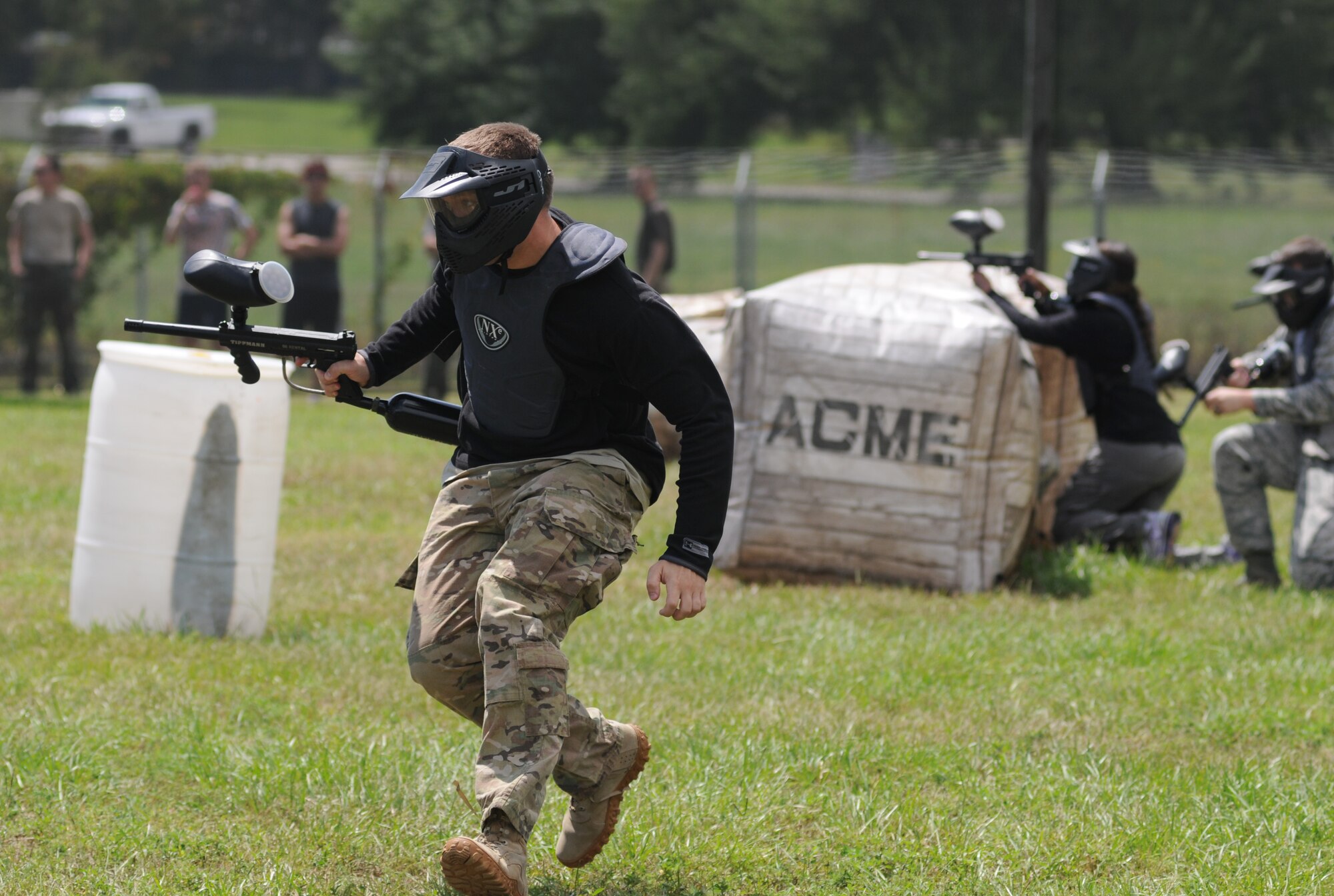 Maj. Jayson Cabell, 81st Comptroller Squadron commander, runs for cover during the Fisher House Fundraiser paintball tournament Sept. 12, 2014, at the paintball complex, Keesler Air Force Base, Miss.  The event also included food, games and a dunking booth. (U.S. Air Force photo by Kemberly Groue)