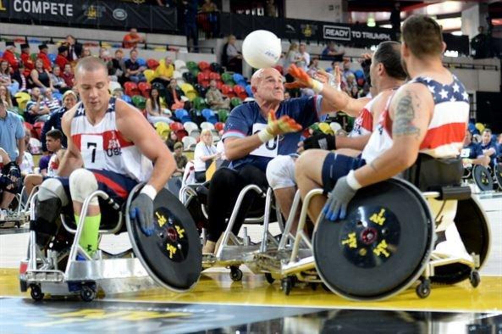 Three American defenders knock the ball away from an Australian player during a wheelchair rugby match Sept. 12, 2014, at the 2014 Invictus Games in London. The U.S. won the match 14-4. Invictus Games is an international competition that brings together wounded, injured and ill service members in the spirit of friendly athletic competition. American Soldiers, Sailors, Airmen and Marines are representing the U.S. in the competition which is taking place Sept. 10-14. (U.S. Navy photo/Mass Communication Specialist 2nd Class Joshua D. Sheppard)
