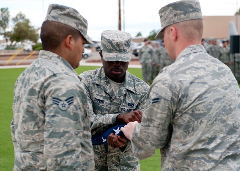 Members of the 49th Wing Steel Talons Honor Guard  fold the flag during a ceremony to commemorate 9/11 at Holloman Air Force Base, N.M., Sept. 11. Team Holloman honored first responders and medical personnel that lost their lives during 9/11 by reciting prayers and creeds.  Holloman AFB pays tribute to those fallen on 9/11 annually with a ceremony at Heritage Park. (U.S. Air Force photo by Senior Airman Daniel E. F. Liddicoet/Released)
