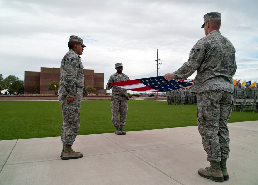 Members of the 49th Wing Steel Talons Honor Guard fold the flag during a ceremony to commemorate 9/11 at Holloman Air Force Base, N.M., Sept. 11. Team Holloman honored first responders and medical personnel that lost their lives during 9/11 by reciting prayers and creeds.  Holloman AFB pays tribute to those fallen on 9/11 annually with a ceremony at Heritage Park. (U.S. Air Force photo by Senior Airman Daniel E. F. Liddicoet/Released)