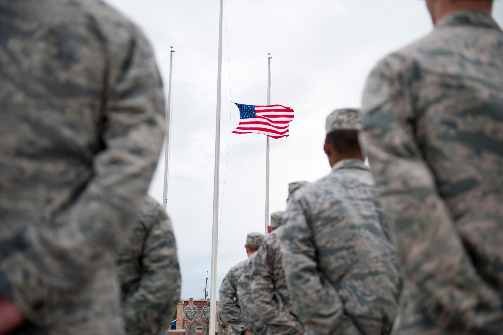 Members of the 49th Wing stand in formation during a ceremony to commemorate 9/11 at Holloman Air Force Base, N.M., Sept. 11. Team Holloman honored first responders and medical personnel that lost their lives during 9/11 by reciting prayers and creeds.  Holloman AFB pays tribute to those fallen on 9/11 annually with a ceremony at Heritage Park. (U.S. Air Force photo by Senior Airman Daniel E. F. Liddicoet/Released)