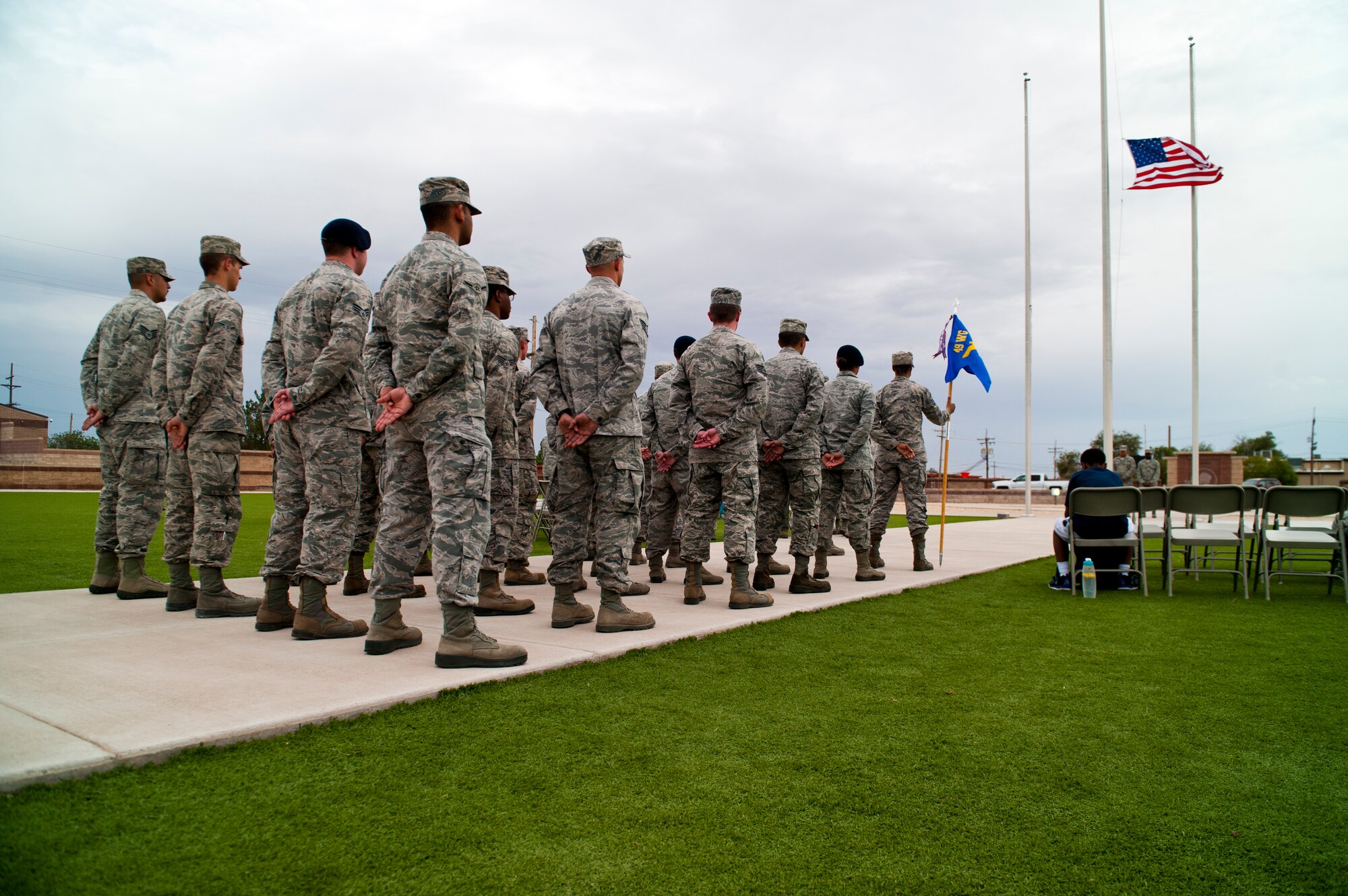 Members of the 49th Wing stand in formation during a ceremony to commemorate 9/11 at Holloman Air Force Base, N.M., Sept. 11. Team Holloman honored first responders and medical personnel that lost their lives during 9/11 by reciting prayers and creeds.  Holloman AFB pays tribute to those fallen on 9/11 annually with a ceremony at Heritage Park. (U.S. Air Force photo by Senior Airman Daniel E. F. Liddicoet/Released)