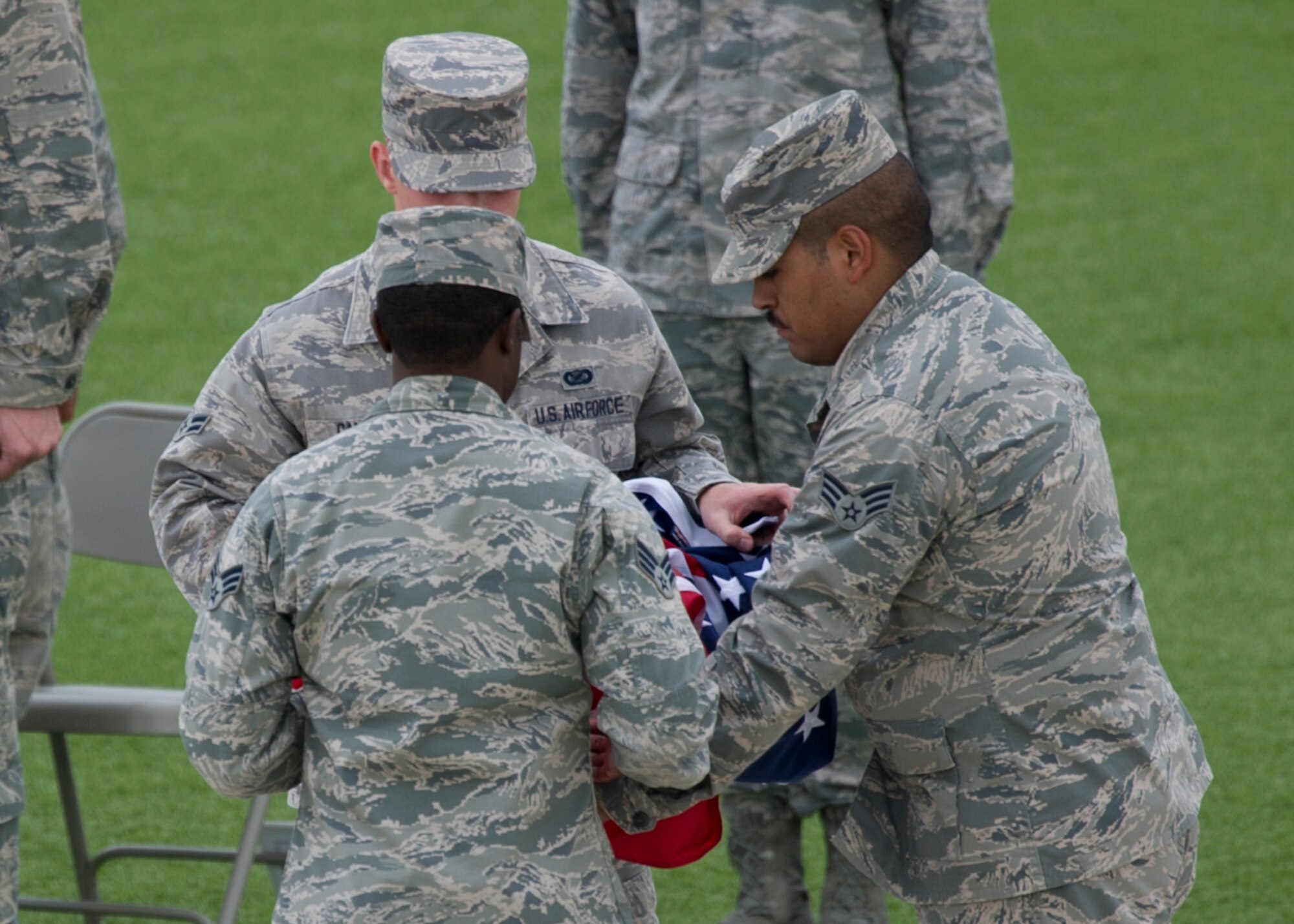 Members of the Steel Talons Honor Guard lower and fold the flag during the September 11th r+emembrance event at Holloman Air Force Base, N.M., Sept. 11. Team Holloman honored first responders and medical personnel that lost their lives during 9/11 by reciting prayers and creeds. Holloman AFB pays tribute to those fallen on September 11th annually with a ceremony at Heritage Park. (U.S. Air Force photo by Airman 1st Class Aaron Montoya / Released)