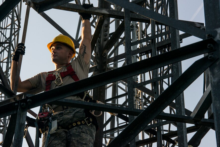 U.S. Air Force Staff Sgt. Cody Ball, 23d Operations Support Squadron airfield systems supervisor, rests on an antenna tower, mid-climb, during a capabilities demonstration Sept. 12, 2014, at Moody Air Force Base, Ga. Airmen from the air traffic control and landing systems flight climb the towers at least once every 84 days to perform preventative maintenance inspections. (U.S. Air Force photo by Airman 1st Class Ryan Callaghan/Released)