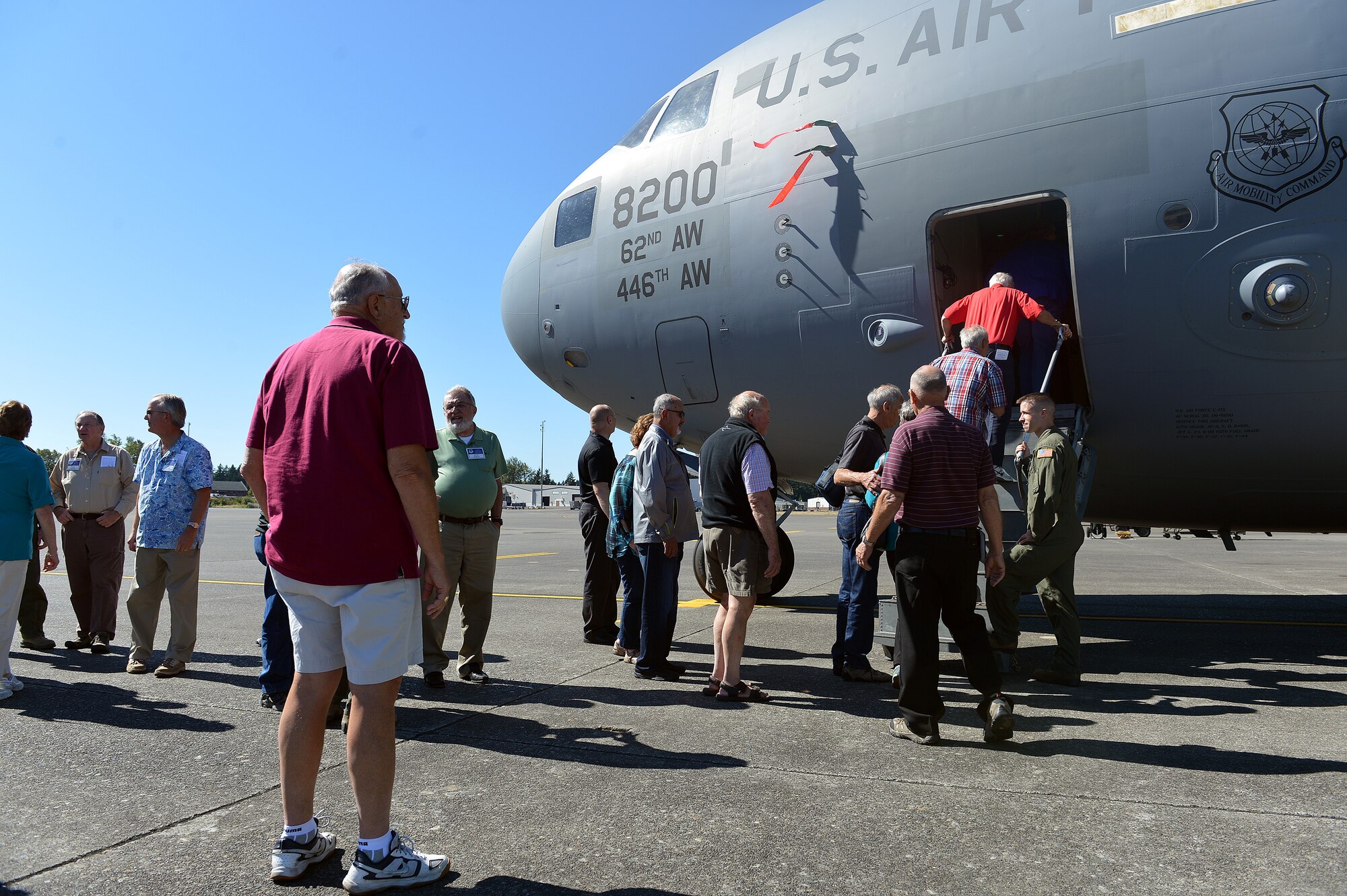 Members from the 62nd Troop Carrier reunion tour walk onto a C-17 Globemaster III Sept. 12, 2014, during their base visit to Joint Base Lewis-McChord, Wash. Many attendees of the reunion were previously Airmen who were assigned to McChord in the 1970s and 1980s and discovered how the base has changed over the years. (U.S. Air Force photo/Airman 1st Class Keoni Chavarria)