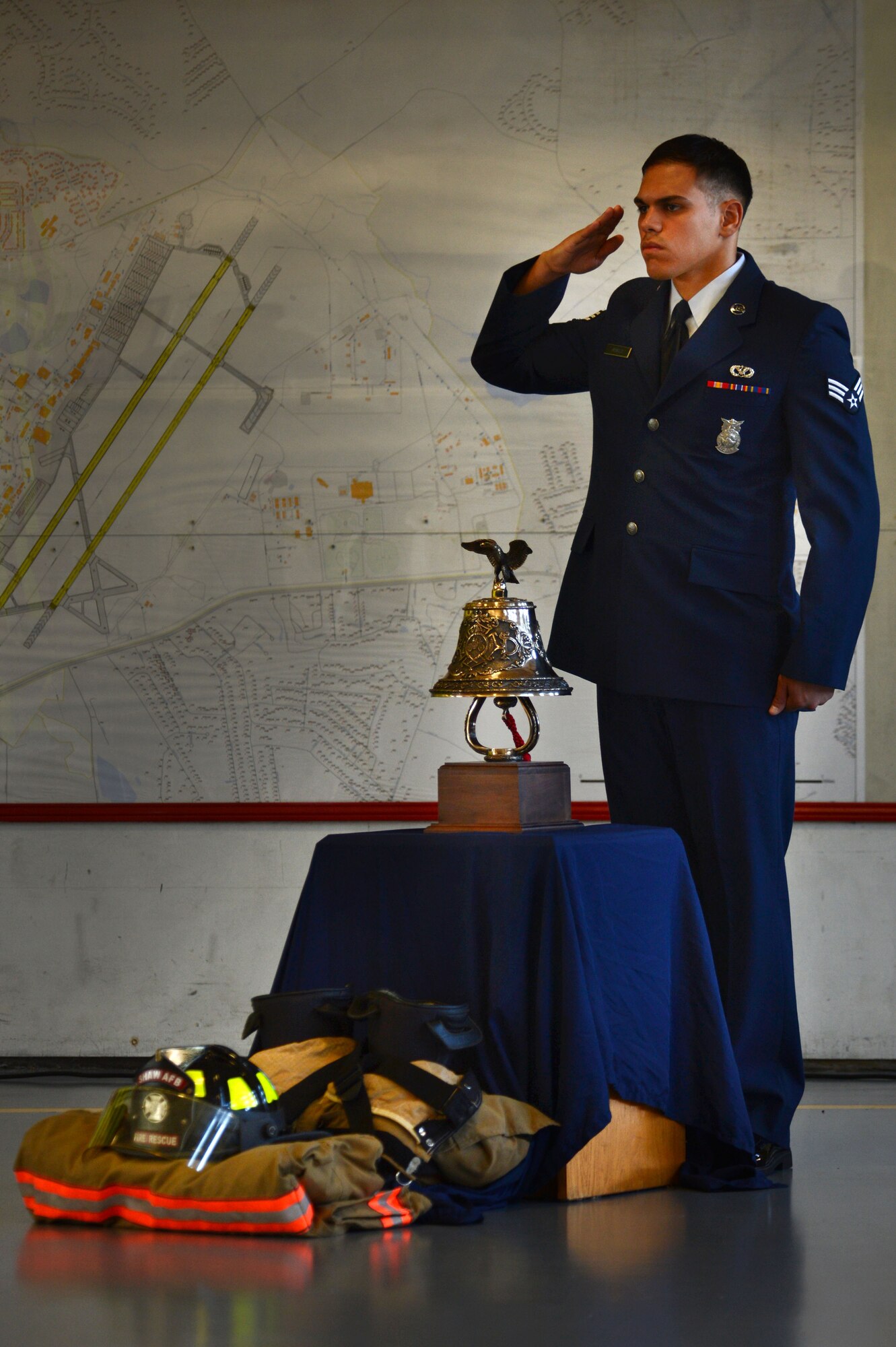 U.S. Air Force Senior Airman Christian Arvelo, 20th Civil Engineer Squadron firefighter, renders a salute during a 9/11 memorial ceremony at Shaw Air Force Base, S.C., Sept. 11, 2014. During the ceremony, members of the 20th CES remembered the firefighters who lost their lives during the attacks on 9/11. (U.S. Air Force photo by Airman 1st Class Jensen Stidham/Released) 