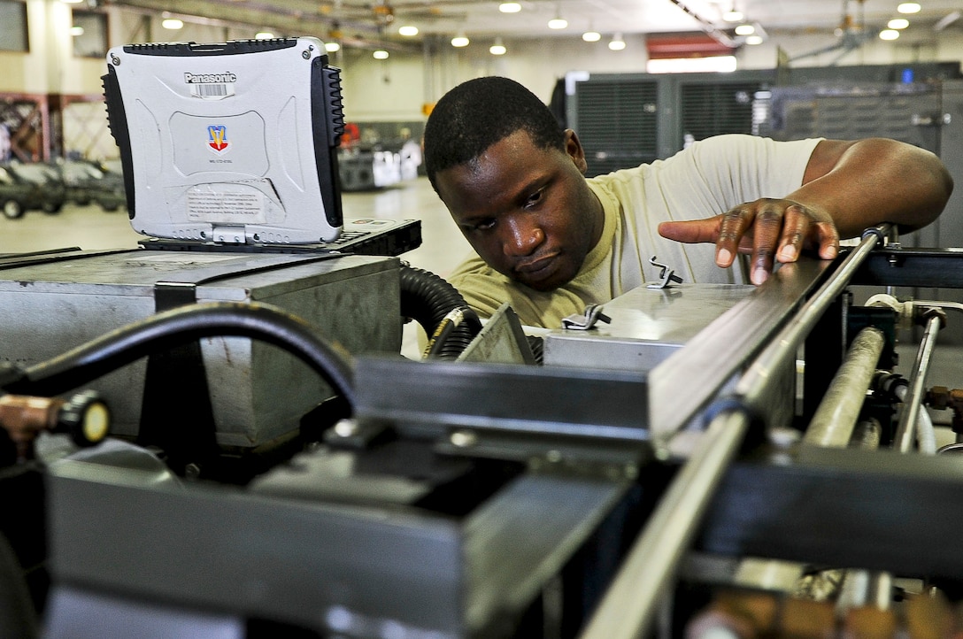 U.S. Air Force Tech Sgt. Bradley Bent, 192nd Fighter Wing aerospace ground equipment technician, recalibrates a stored energy system servicing cart at Langley Air Force Base, Va., Sept. 10, 2014.  Aerospace ground equipment Airmen work with electrical components, various circuitries and hydraulic systems, and their shop’s mission is to produce Airmen ready to join the fight and provide the ground power necessary to maintain air superiority. (U.S. Air Force photo by Senior Airman Connor Estes/Released)