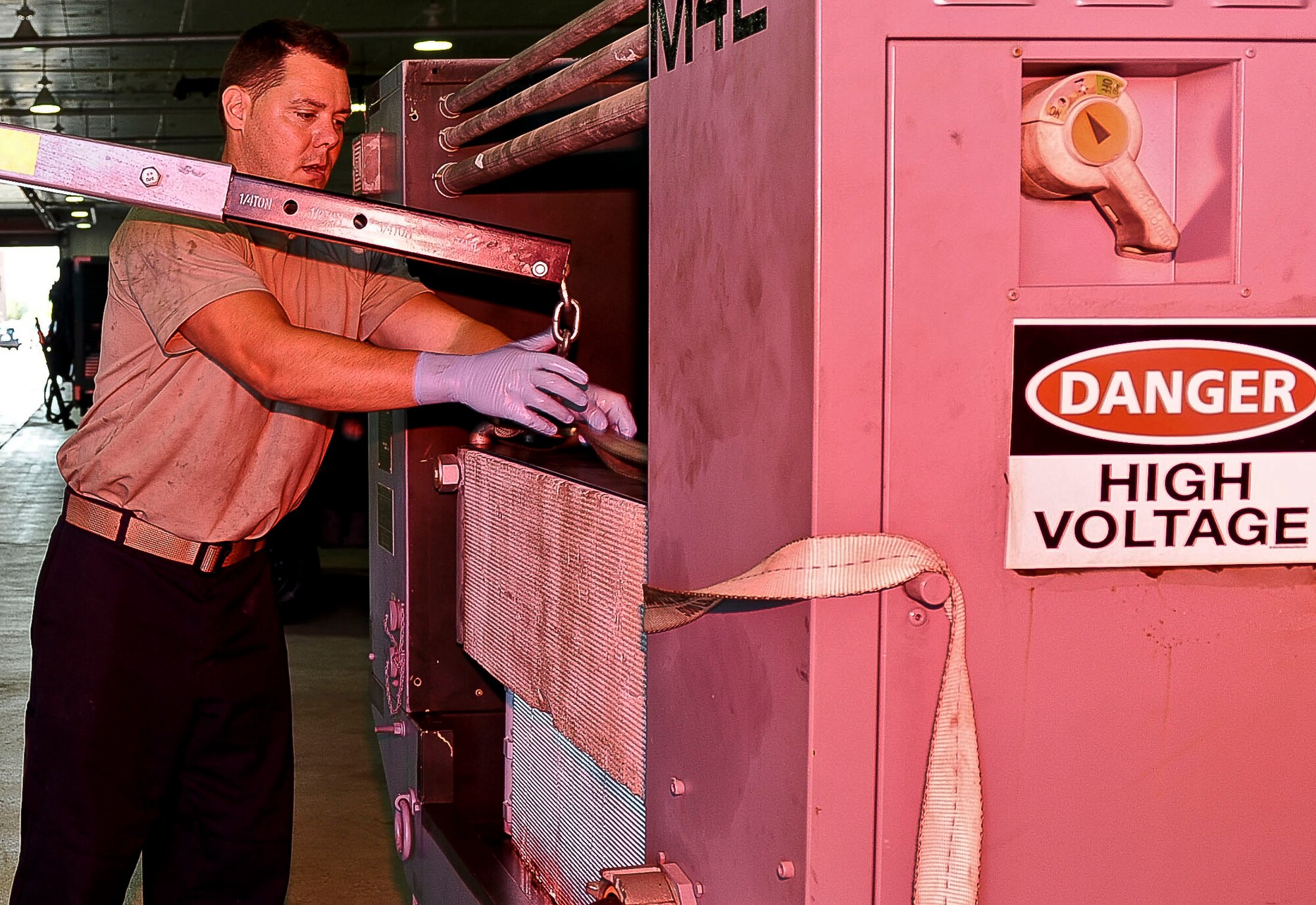 U.S. Air Force Tech Sgt. William Bandy, 192nd Fighter Wing aerospace ground equipment technician, removes a piece of equipment from an electric hydraulic test stand unit at Langley Air Force Base, Va., Sept. 10, 2014.  Aerospace ground equipment Airmen maintain different pieces of equipment that support flight line operations. (U.S. Air Force photo by Senior Airman Connor Estes/Released)