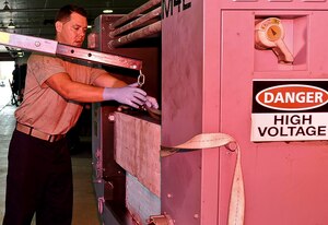 U.S. Air Force Tech Sgt. William Bandy, 192nd Fighter Wing aerospace ground equipment technician, removes a piece of equipment from an electric hydraulic test stand unit at Langley Air Force Base, Va., Sept. 10, 2014.  Aerospace ground equipment Airmen maintain different pieces of equipment that support flight line operations. (U.S. Air Force photo by Senior Airman Connor Estes/Released)