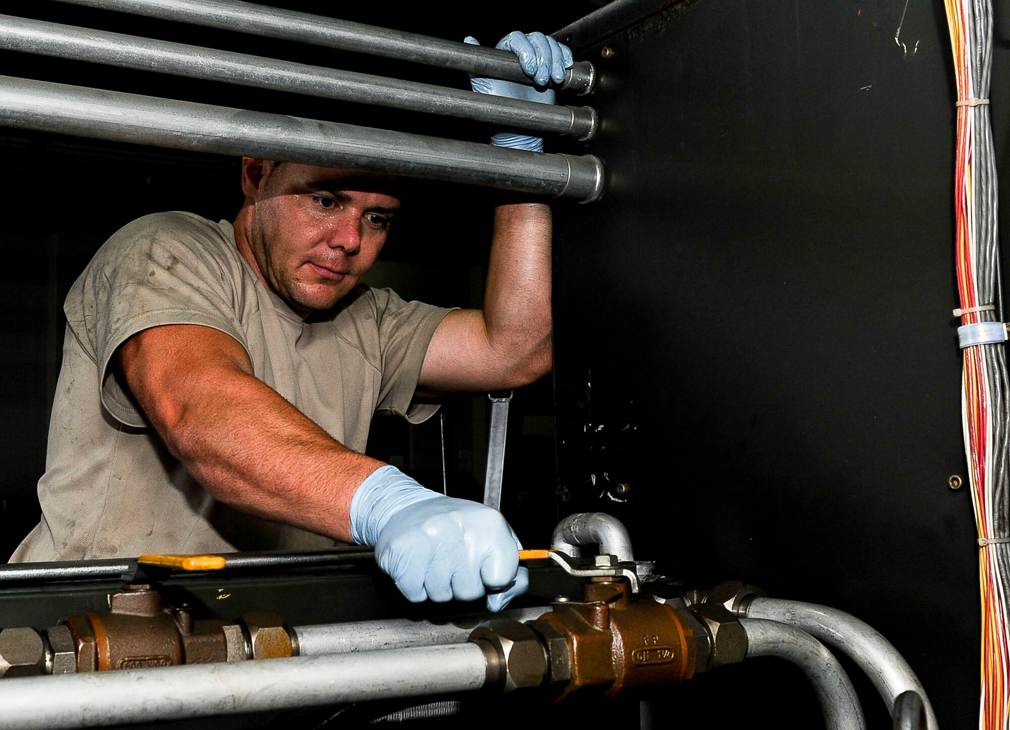 U.S. Air Force Tech Sgt. William Bandy, 192nd Fighter Wing aerospace ground equipment technician, ensures a valve is closed on an electric hydraulic test stand unit at Langley Air Force Base, Va., Sept. 10, 2014.  Aerospace ground equipment Airmen serve as a key element to the aircraft mission, ensuring proper maintenance can be performed on each aircraft. The Airmen are also certified in maintaining heating, ventilation and air conditioning systems. (U.S. Air Force photo by Senior Airman Connor Estes/Released)
