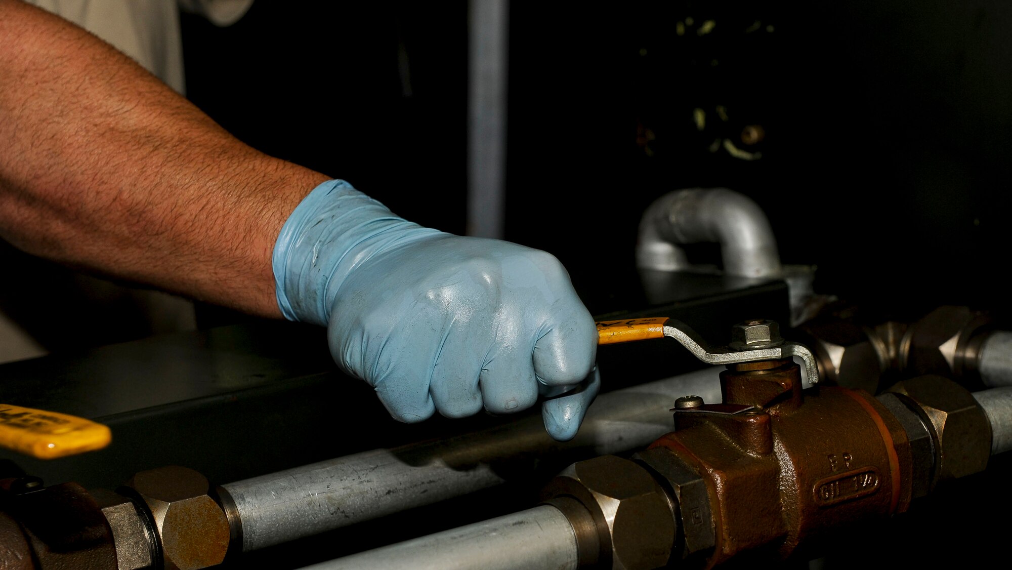 U.S. Air Force Tech. Sgt. William Bandy, 192nd Fighter Wing aerospace ground equipment technician, closes a valve on an electric hydraulic test stand unit at Langley Air Force Base, Va., Sep. 10, 2014.  The equipment AGE Airmen support includes bomb loaders, munitions trailers and lights used at night on the flight line. (U.S. Air Force photo by Senior Airman Connor Estes/Released)