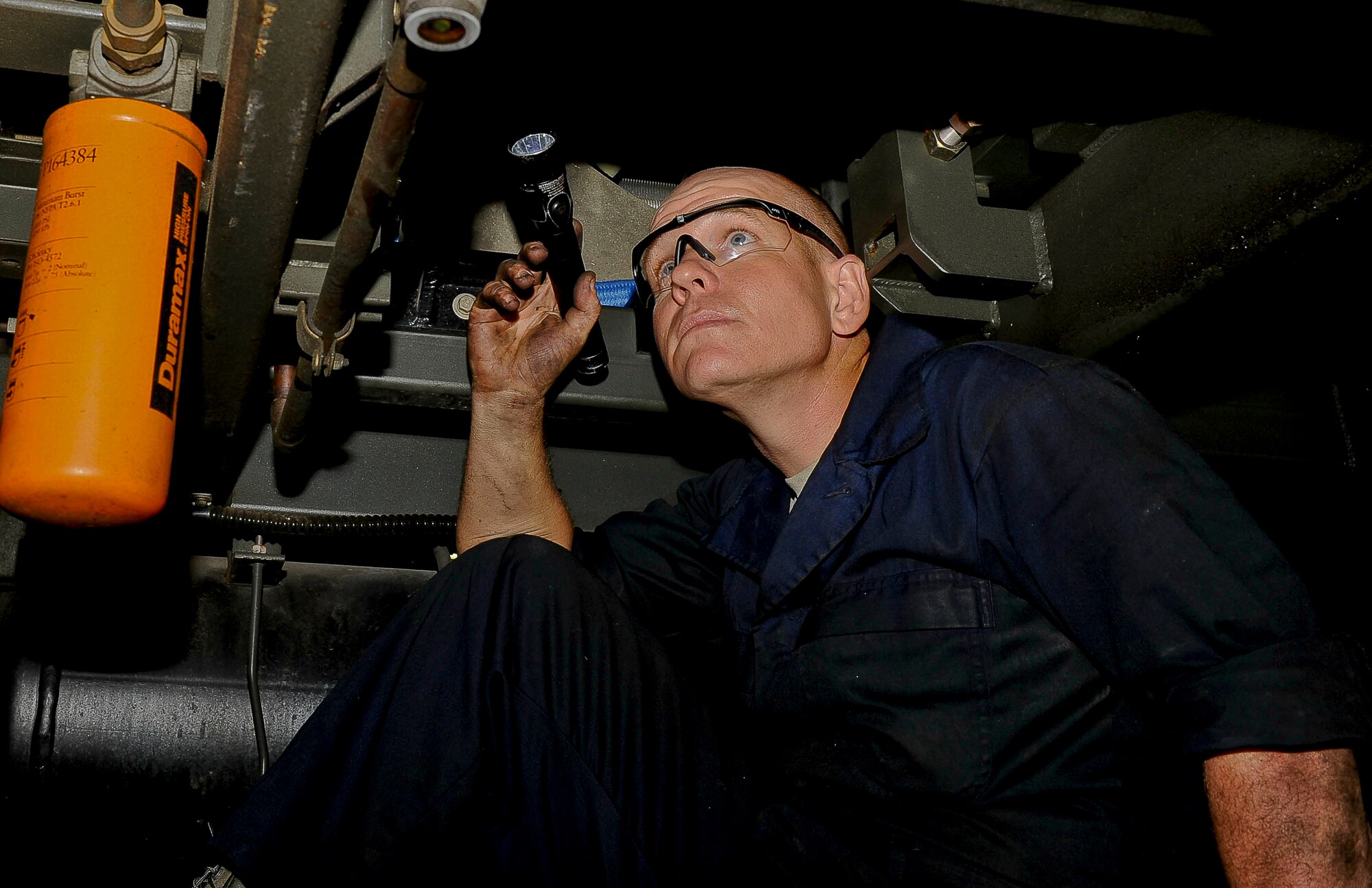 U.S. Air Force Tech Sgt. Trent Baker, 192nd Fighter Wing aerospace ground equipment technician, inspects a valve on a polyalphaolefin air cooling cart at Langley Air Force Base, Va., Sept. 10, 2014.  The cart provides cooling air and fluid to aircraft. (U.S. Air Force photo by Senior Airman Connor Estes/Released)