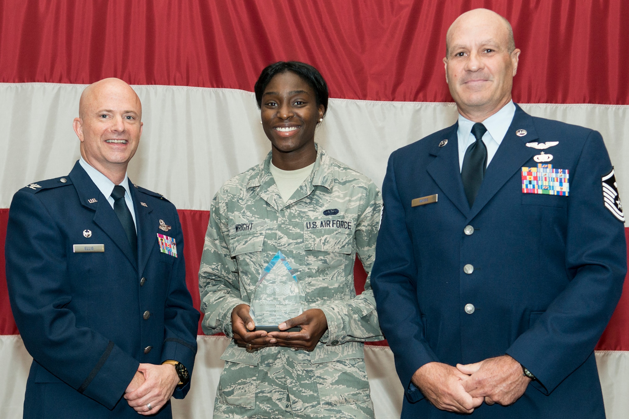 U.S. Air Force Senior Airman Monique Wright is presented the Diamond Sharp Award during a 307th Bomb Wing Commander's Call, Sept. 7, 2014, Barksdale Air Force Base, La. Wright is assigned to the 307th Maintenance Group and the award was presented by the First Sergeant Council. (U.S. Air Force photo by Master Sgt. Greg Steele/Released)