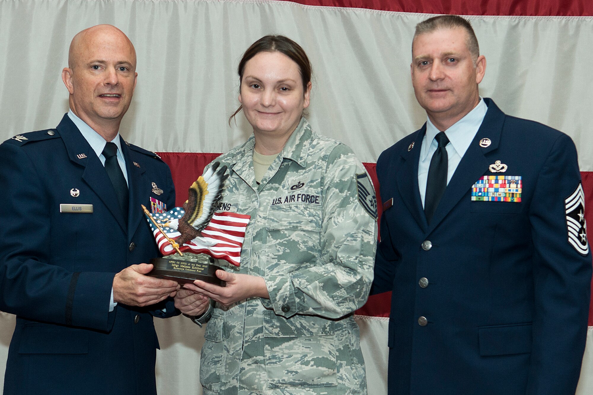 U.S. Air Force Master Sgt. Melissa Kitchens is presented the Air Force Reserve Command's C2 Senior Noncommissioned Officer of the Year award, Sept. 7, 2014, Barksdale Air Force Base, La. Kitchens is assigned to the 307th Bomb Wing and works in the Command Post. (U.S. Air Force photo by Master Sgt. Greg Steele/Released)
