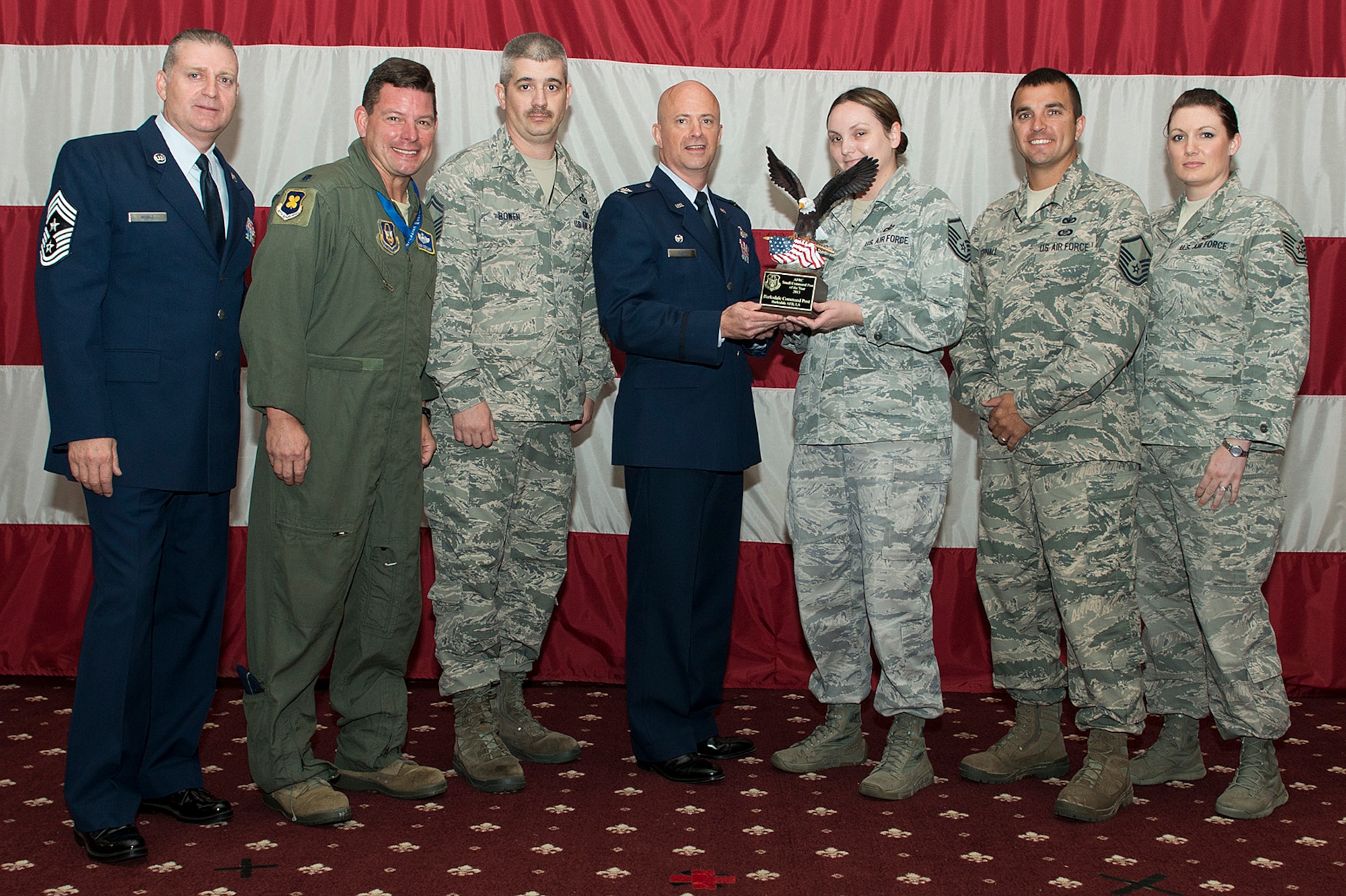 Members of the Command Post receive an award during the 307th Bomb Wing Commander's Call, Sept. 7, 2014, Barksdale Air Force Base, La. The team was selected as the 2013 Small Command Post of the Year. (U.S. Air Force photo by Master Sgt. Greg Steele/Released)