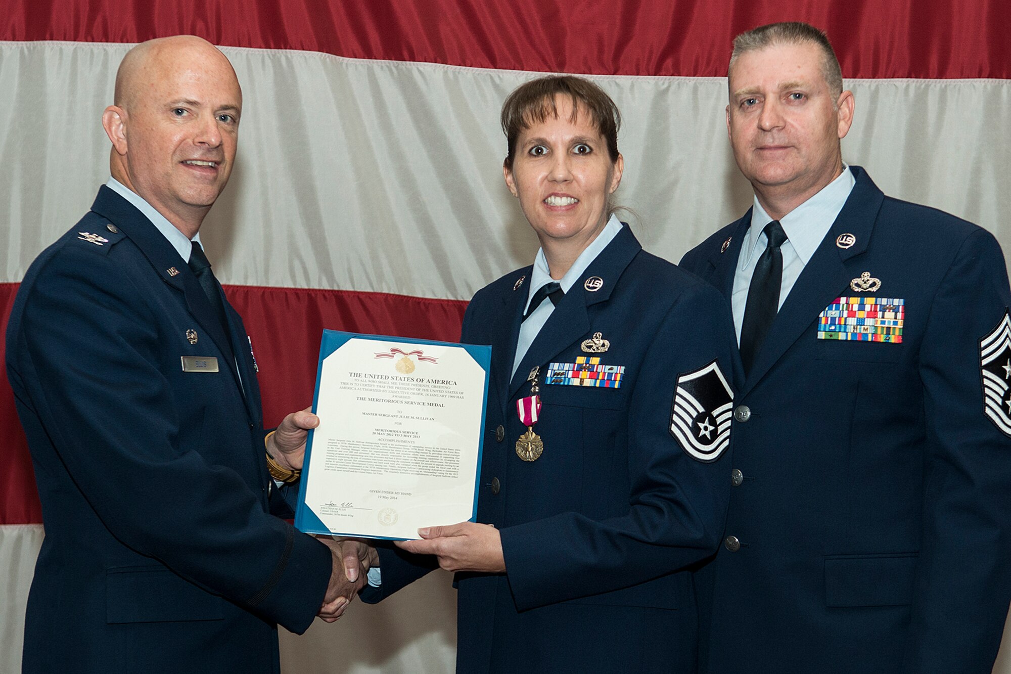 U.S. Air Force Master Sgt. Julie Sullivan is awarded the Air Force Meritorious Service Medal during a 307th Bomb Wing Commander's Call, Sept. 7, 2014, Barksdale Air Force Base, La. Sullivan distinguished herself in the performance of outstanding service to the United States while assigned to the 307th Maintenance Operations Flight for the period of May 2012 to May 2013. (U.S. Air Force photo by Master Sgt. Greg Steele/Released)