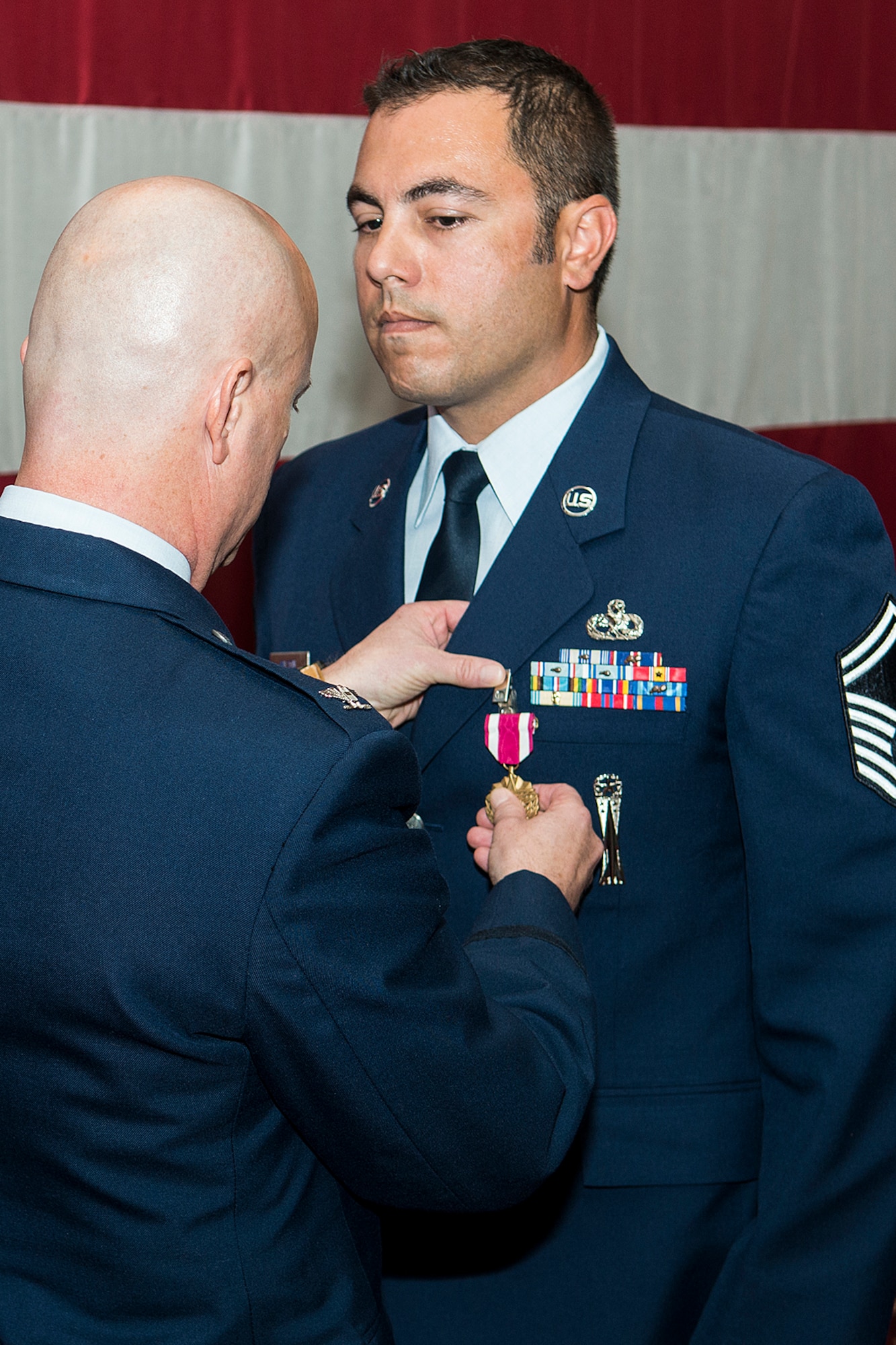 U.S. Air Force Col. Jonathan Ellis, 307th Bomb Wing commander, awards the Air Force Meritorious Service Medal to Senior Master Sgt. Jonathan Wilson, Sept. 7, 2014, Barksdale Air Force Base, La. Wilson distinguished himself by outstanding achievement while assigned to the 707th Maintenance Squadron from June 2013 to January 2014. (U.S. Air Force photo by Master Sgt. Greg Steele/Released)