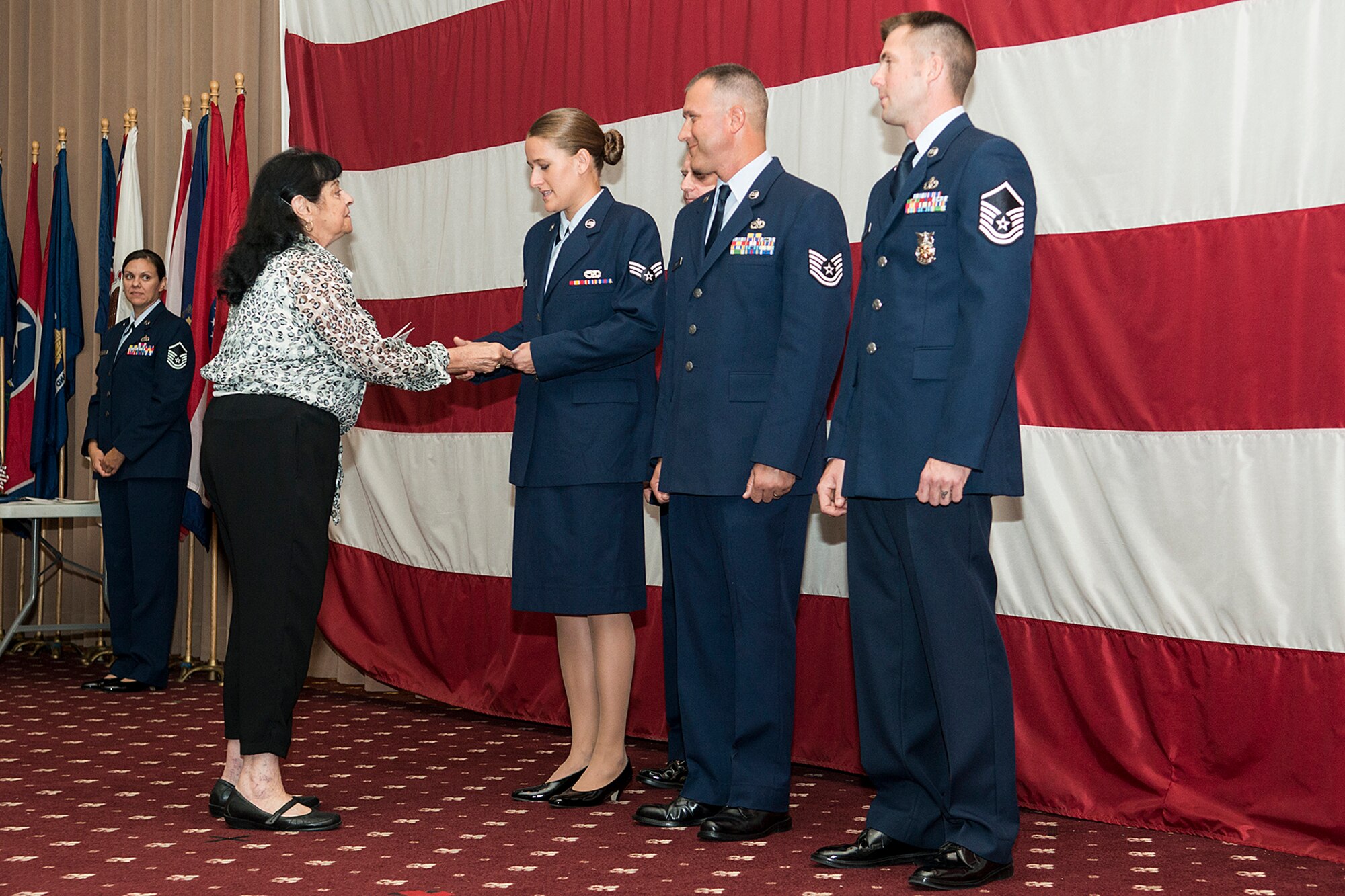 Catherine Vanderberry, representing the Bossier Council Seniors and the Barksdale Retirees, presents a gift certificate to Senior Airman Jacquelyn Espinoza in recognition of her being selected Airman of the Quarter, Sept. 7, 2014, Barksdale Air Force Base, La. Also receiving gift certificates is Noncommissioned Officer of the Quarter Tech. Sgt. Mark Chumley and Senior Noncommissioned Officer of the Quarter Master Sgt. Jonathan Rapelje. (U.S. Air Force photo by Master Sgt. Greg Steele/Released)