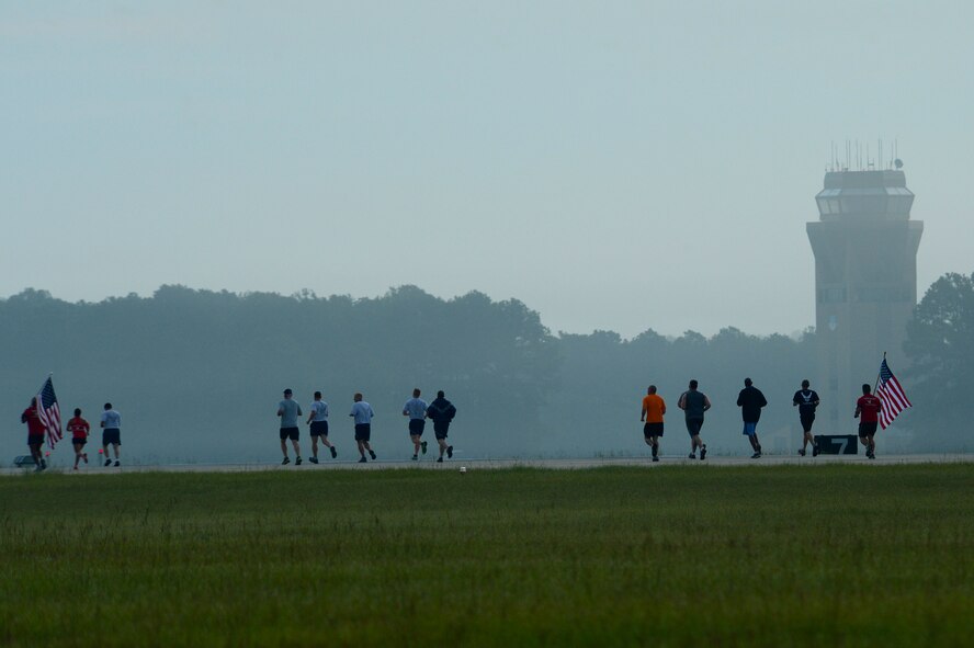 Members of Team Shaw run a 9/11 memorial 5k race on the flightline at Shaw Air Force Base, S.C., Sept. 11, 2014. The 5k run was the first ever race held on the flightline. (U.S. Air Force photo by Airman 1st Class Jensen Stidham/Released)