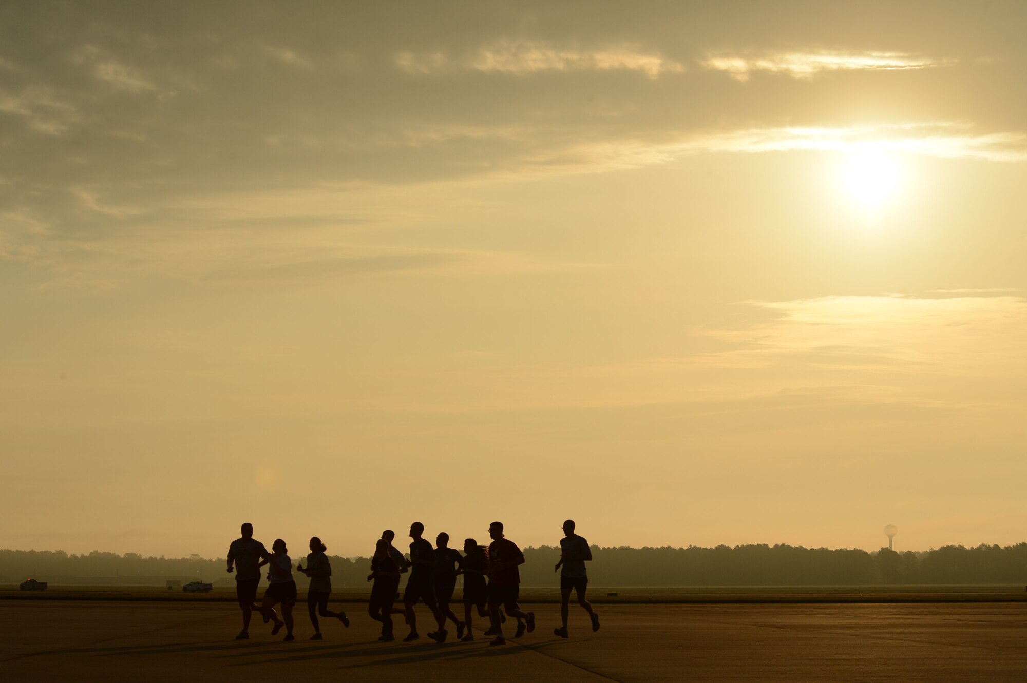 Members of Team Shaw run a 9/11 memorial 5k race on the flightline at Shaw Air Force Base, S.C., Sept. 11, 2014. The Shaw Top 3 and the First Sergeant Council hosted the first ever flightline run as a memorial for those who lost their lives during 9/11. (U.S. Air Force photo by Airman 1st Class Jensen Stidham/Released)