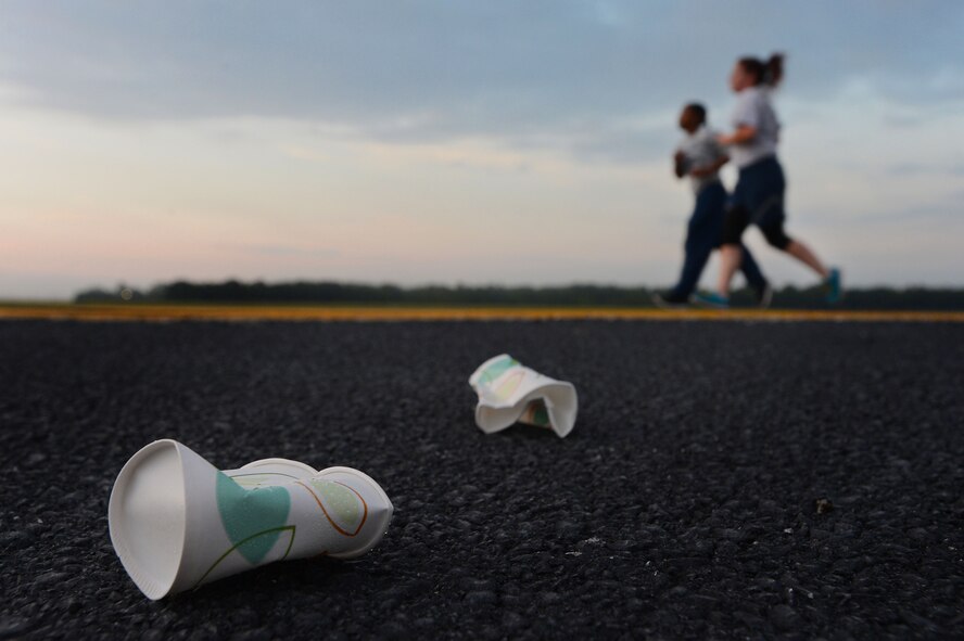 Crushed paper cups lay on the flightline during a 5k run at Shaw Air Force Base, S.C., Sept. 11, 2014. Two water stands were set up for Team Shaw members to hydrate during the 9/11 memorial run. (U.S. Air Force photo by Airman 1st Class Jensen Stidham/Released) 