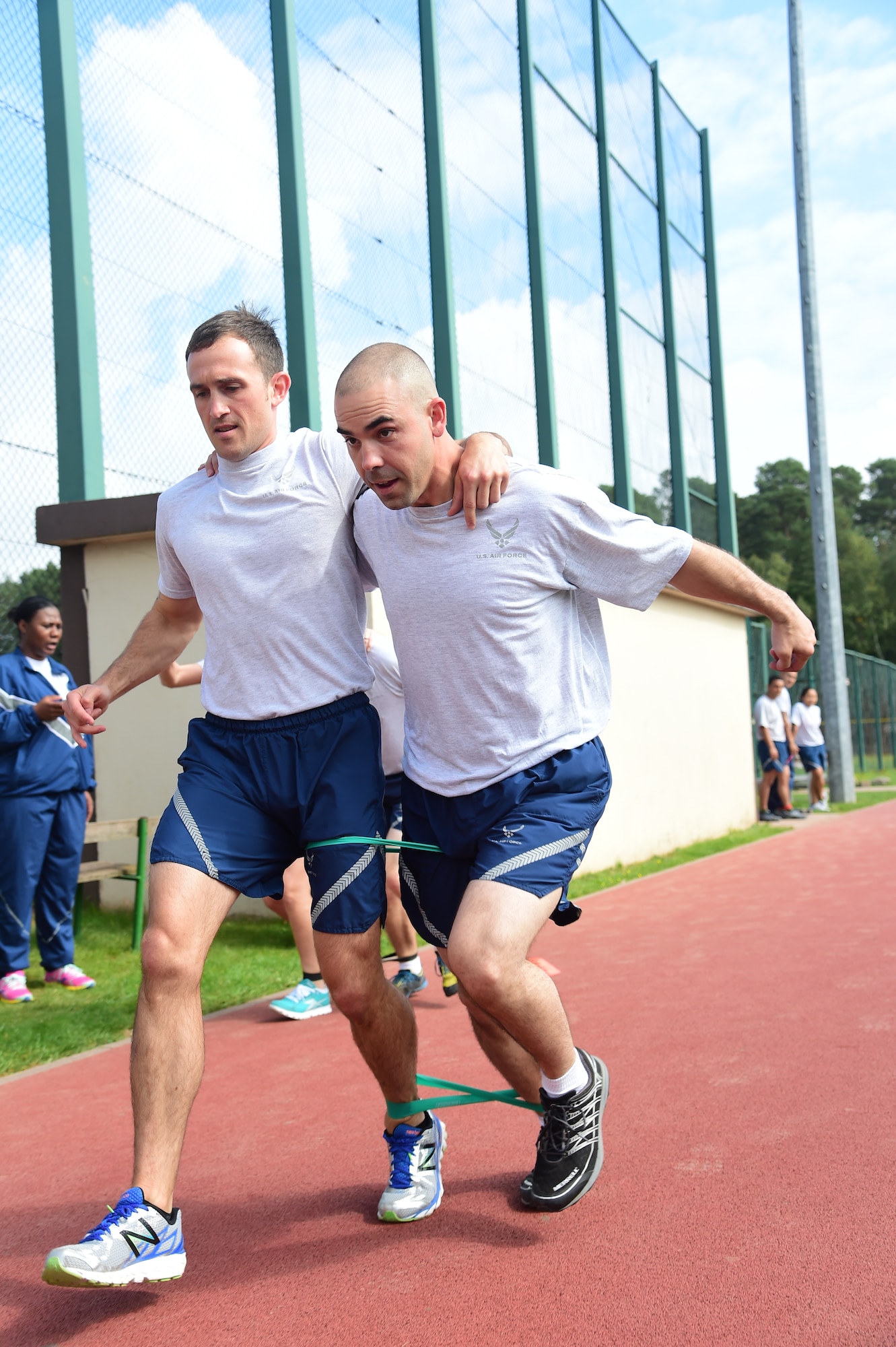 Tech. Sgts. Michael Bambarger and Joshua Velazquez, both 700th Contracting Squadron contracting officers, work together during the three-legged race Sept. 11, 2014, at Ramstein Air Base, Germany. Bambarger and Velazquez took first place with the fastest time of 16.18 seconds during this Commander’s Challenge event. (U.S. Air Force photo/Staff Sgt. Travis Edwards)