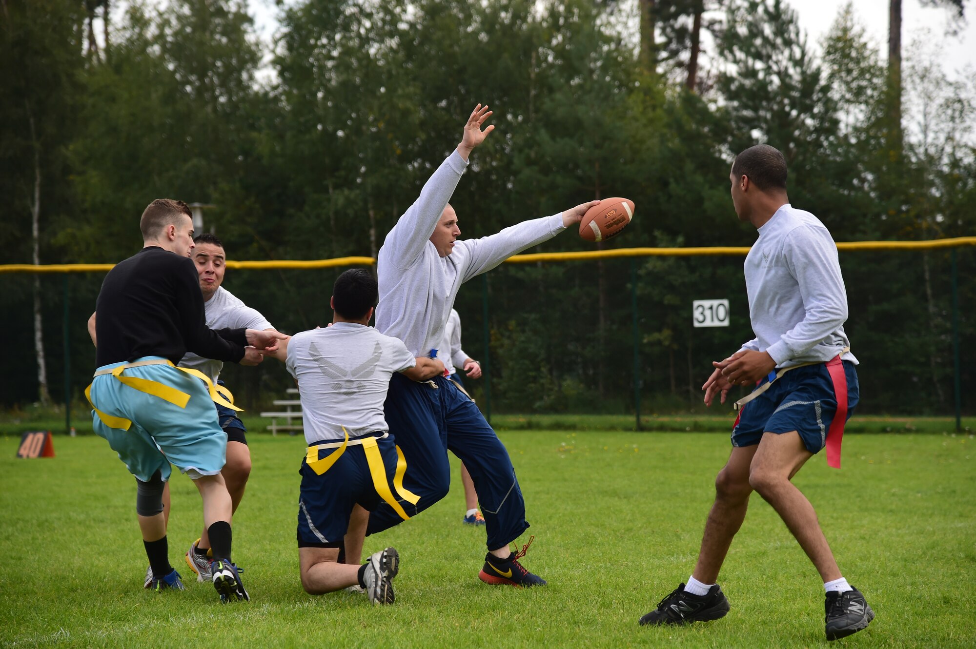 Airmen from the 86th Comptroller Squadron remove flags from an 86th Security Forces Squadron member during a flag football game Sept. 11, 2014 at Ramstein Air Base, Germany. Flag football was one of many sporting events to take place here during Resiliency Day. Resilience Day was a day for Airmen to enjoy friendly competition amongst squadrons within the 86th Airlift Wing to obtain the coveted Commander’s Challenge trophy. (U.S. Air Force photo/Staff Sgt. Travis Edwards)