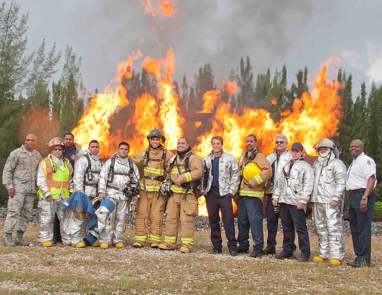 Aric Almirola, driver of the No. 43 Richard Petty Motorsports Ford racecar, poses for a photo with members of the 482nd Mission Support Group Fire Department after he participated in a live fire exercise at Homestead ARB, Fla., Sept. 10. Almirola visited Homestead ARB before heading to Chicagoland Speedway to participate in the “Chase for the NASCAR Sprint Cup”. (U.S. Air Force photo/Senior Airman Aja Heiden)