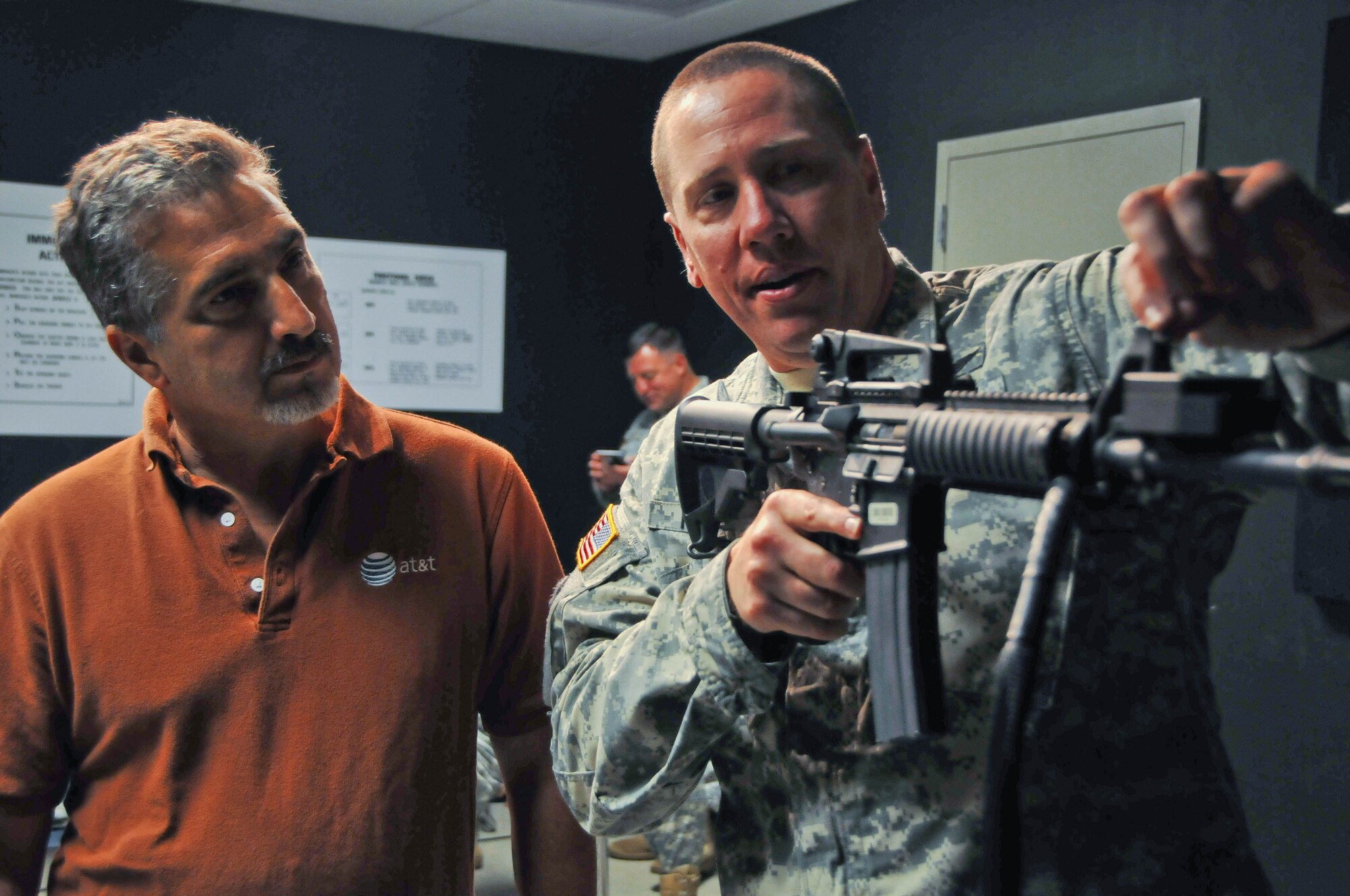 Staff Sgt. Christopher Fritzke, operations non commissioned officer, Headquarters and Headquarters Company, 244th Aviation Brigade, demonstrates how to properly fire a M4 rifle during the 244th's Employer Appreciation Day at Joint Base McGuire-Dix-Lakehurst, N.J., Sept. 9, 2014. (U.S. Army photo by Capt. Christina Douglas/Released)