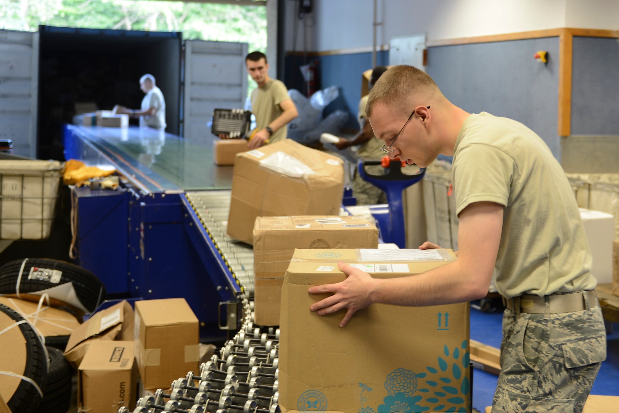 Senior Airman Colin Forney, 86th Communications Squadron postal specialist, sorts packages at the Northside post office on Ramstein Air Base, Sept. 9, 2014. In an average month, Ramstein processes about 55,000 personal packages and about 5,000 official packages. (U.S. Air Force photo/Airman 1st Class Michael Stuart) 