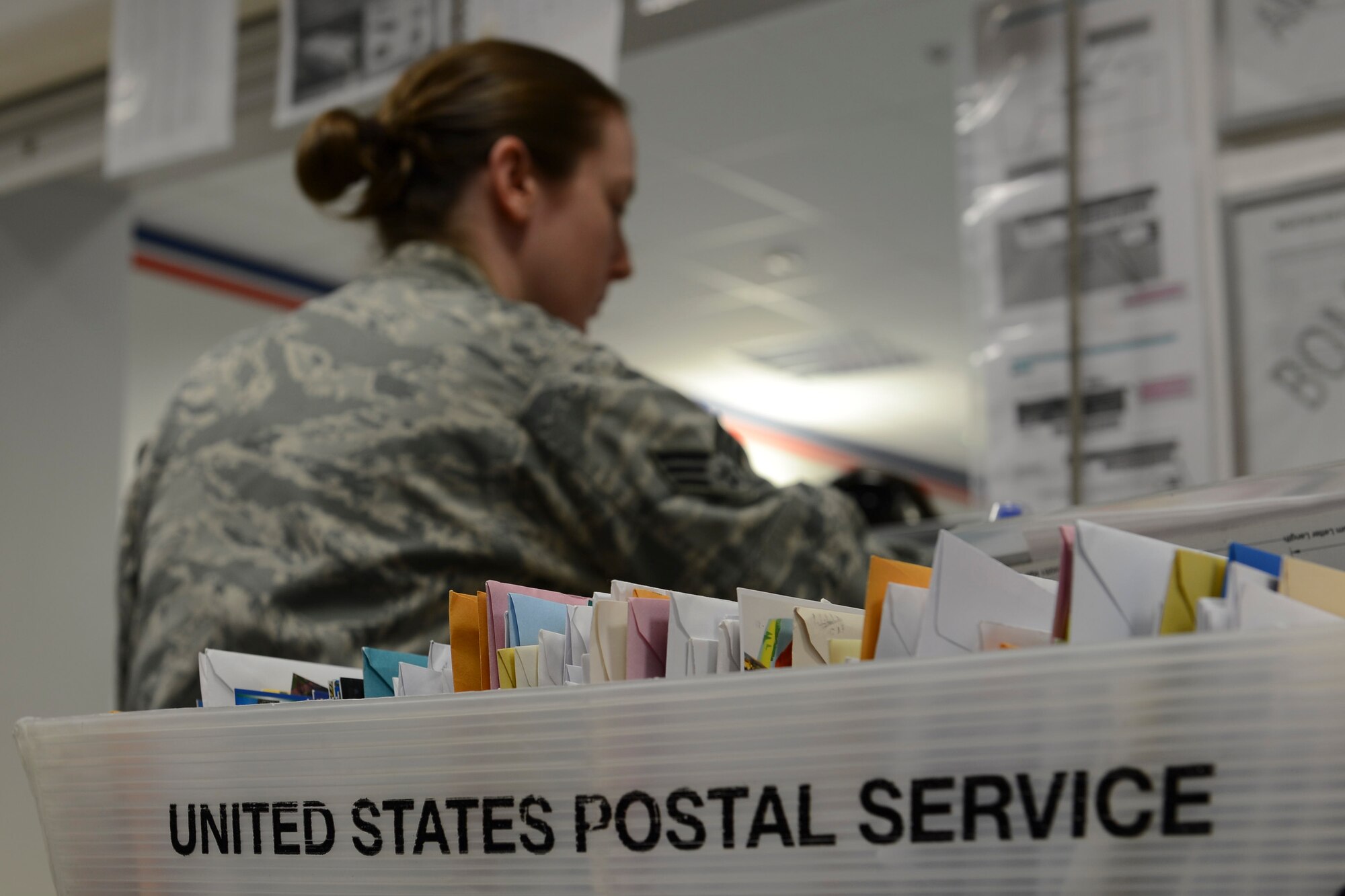Senior Airman Alicia Arensdorf, 86th Communications Squadron finance clerk, works the finance counter at the Northside post office on Ramstein Air Base, Sept. 9, 2014. There are 136 units they deliver to on a daily basis, as well as interact with more than 700 activity distribution officers to get the packages out. (U.S. Air Force photo/Airman 1st Class Michael Stuart)