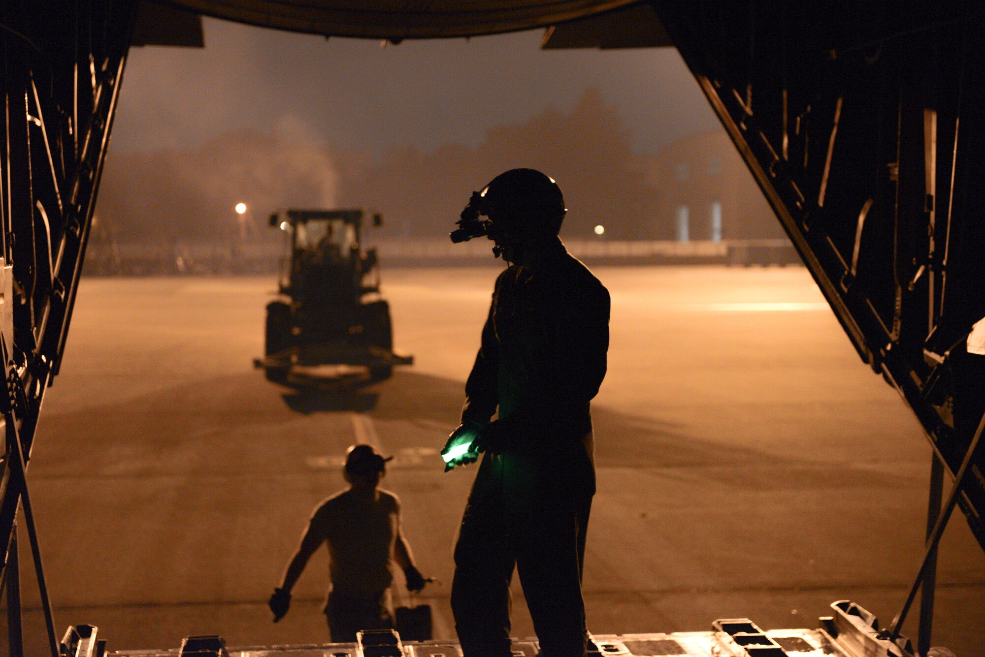Staff Sgt. Kyle Favorite, 36th Airlift Squadron loadmaster, conducts a combat offload at Yokota Air Base, Japan, Sept. 11, 2014. The offload was done to showcase the 36 AS’s night vision capabilities to Japan Air Self-Defense Force members. (U.S. Air Force photo by Staff Sgt. Cody H. Ramirez/Released)