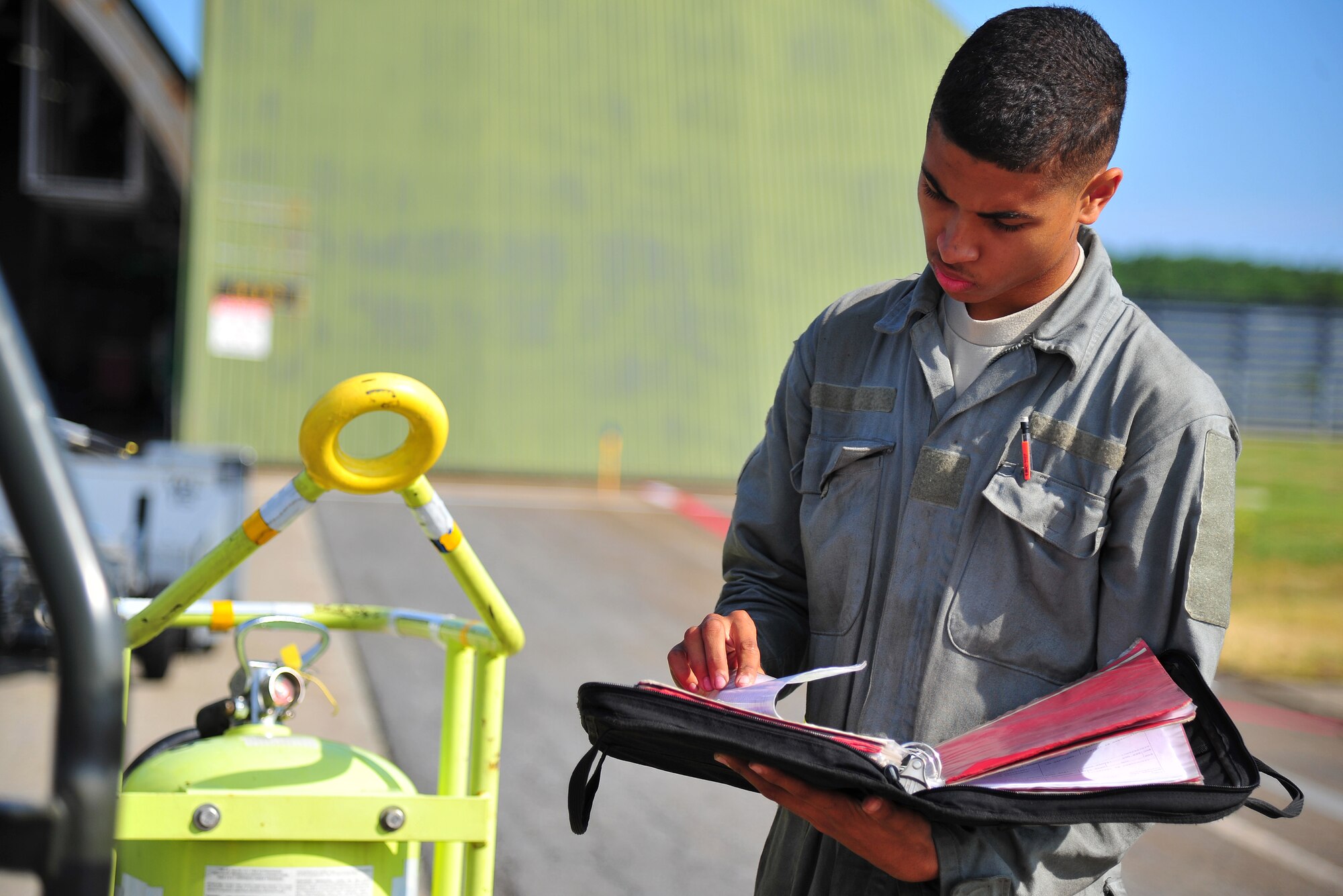U.S. Air Force Airman 1st Class Kyle Lacy, 14th Aircraft Maintenance Unit crew chief, reviews technical orders as part of an inspection of an F-16 Fighting Falcon during Exercise Beverly Sunrise 14-08 at Misawa Air Base, Japan, Sept. 14, 2014. This exercise focused on the base’s maintenance and operation group’s ability to generate rapid-response airpower. (U.S. Air Force photo by Senior Airman Jose L. Hernandez-Domitilo/Released)