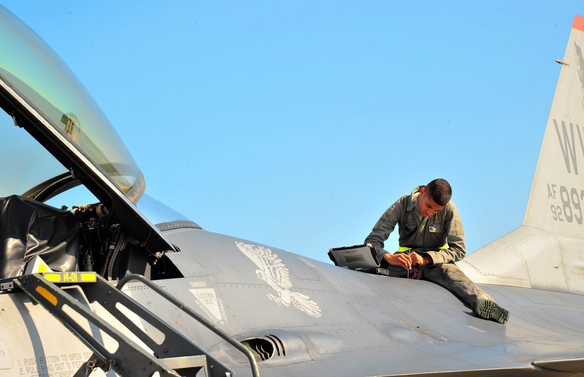 U.S. Air Force Airman 1st Class Kyle Lacy, 14th Aircraft Maintenance Unit crew chief, tightens a screw on the body of an F-16 Fighting Falcon during Exercise Beverly Sunrise 14-08 at Misawa Air Base, Japan, Sept. 14, 2014. As part of an aircraft inspection prior to flight, Lacy ensures the airframe is in proper working order. (U.S. Air Force photo by Senior Airman Jose L. Hernandez-Domitilo/Released)