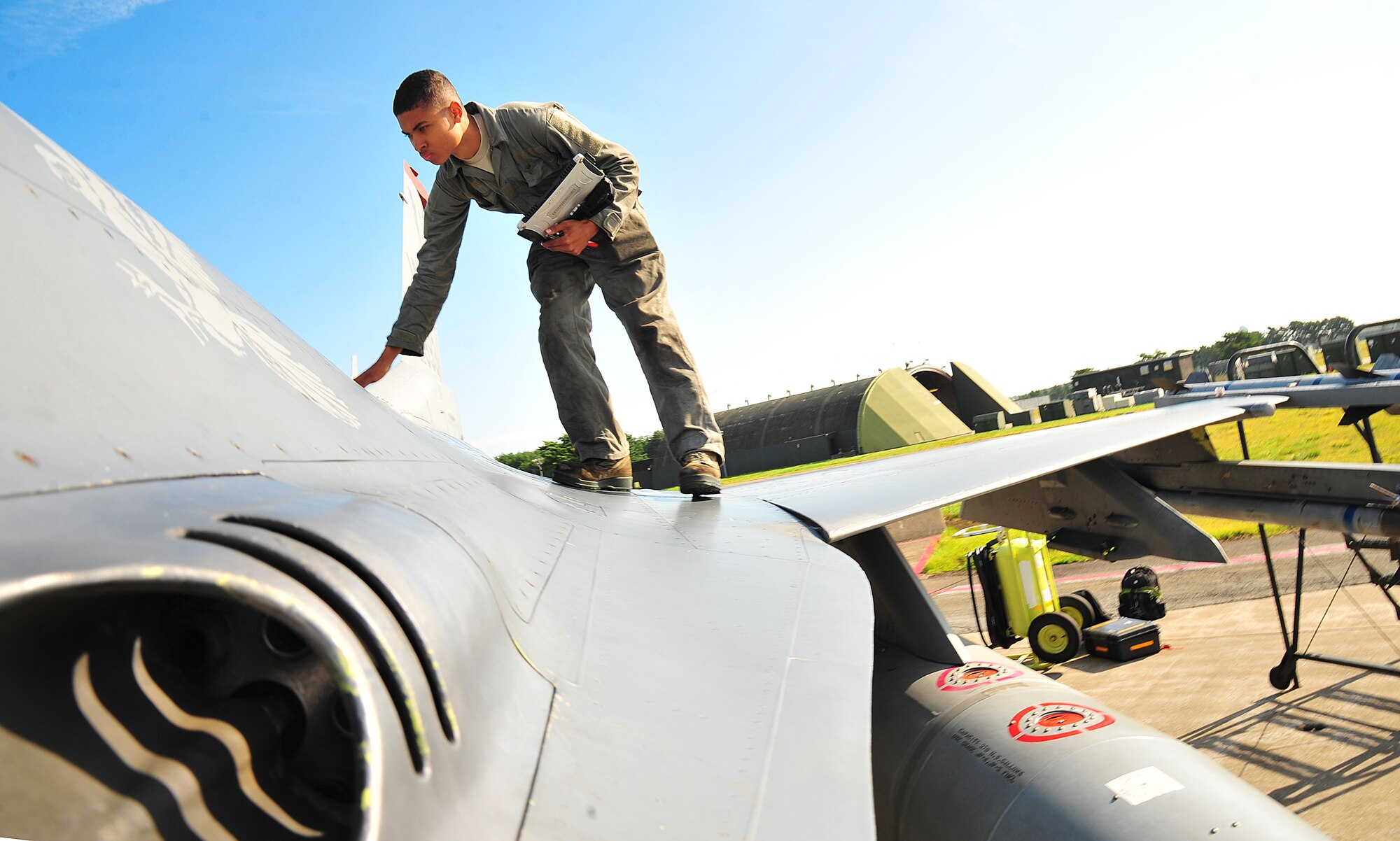 U.S. Air Force Airman 1st Class Kyle Lacy, 14th Aircraft Maintenance Unit crew chief, checks for any loose screws on an F-16 Fighting Falcon during Exercise Beverly Sunrise 14-08 at Misawa Air Base, Japan, Sept. 14, 2014.  Crew chiefs perform aircraft inspections to ensure everything is in working order before flight. (U.S. Air Force photo by Senior Airman Jose L. Hernandez-Domitilo/Released)