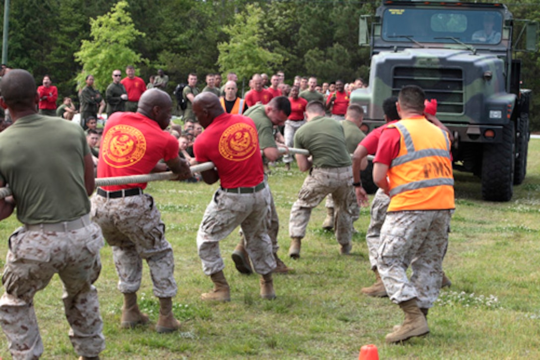 Marine students and staff of Financial Management School, Marine Corps Combat Service Support Schools (MCCSSS), participate in the 7 ton pull during MCCSSS field meet aboard Camp Johnson, N.C., April 25, 2014. Marine students and staff of MCCSSS participate in the field meet to encourage camaraderie and motivation among all the schools The field meet is held semi-annually and consists of 8 events which include tugs of war, stretcher carry, combat conditioning, soccer, volleyball, etc. After the competition concluded the MCCSSS Commanders Cup was awarded to the Marine students and staff of FMS. (U.S. Marine Corps Combat Camera photo by Sergeant Mark E. Morrow/Released)