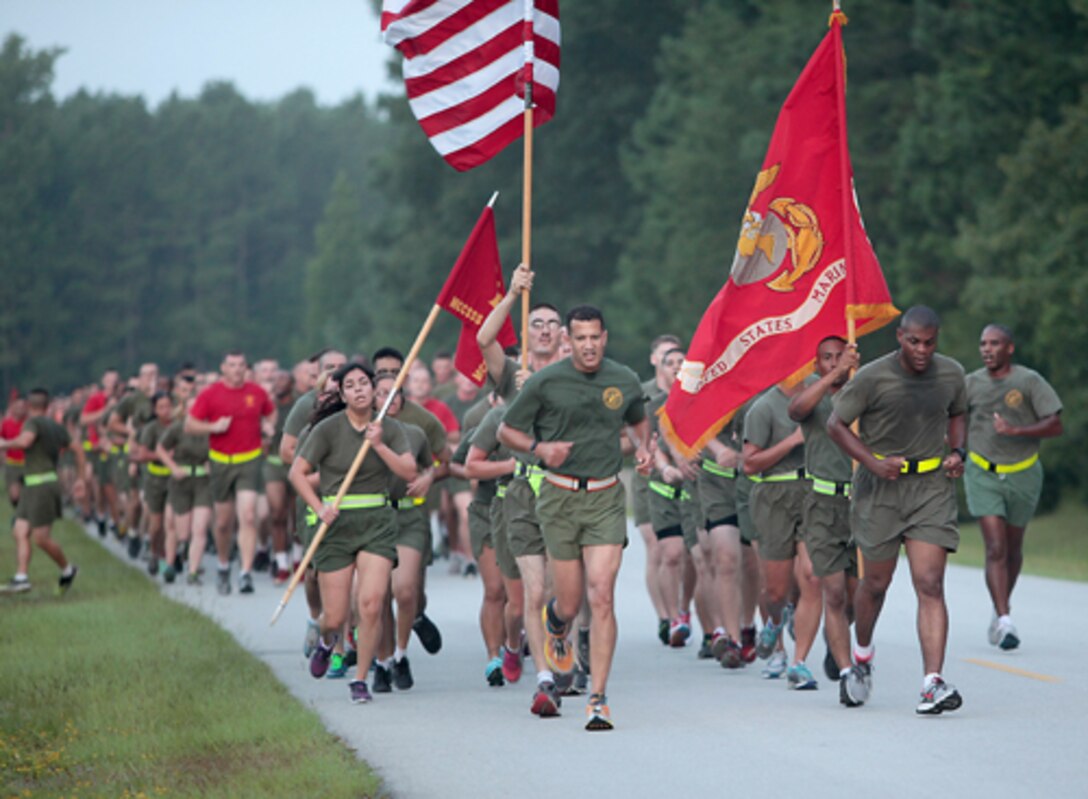 Lieutenant Colonel David E. Jones (center), Commanding Officer, Marine Corps Combat Service Support Schools (MCCSSS), leads the Marines of MCCSSS in a command run aboard Camp Johnson, N.C., Aug. 7, 2014. MCCSSS conducted a command run to promote unit cohesion, camaraderie, and physical fitness. (U.S. Marine Corps Combat Camera photo by Sergeant Mark E. Morrow/Released)
