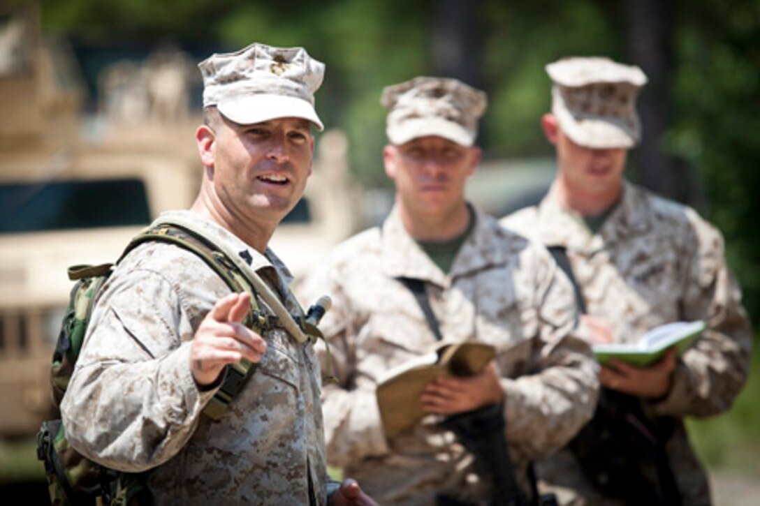 Gunnery Sergeant Damien A. LeClair, Instructor, Logistics Officers Course (LOC), class 4-14, Logistics Operations School, Marine Corps Combat Service Support Schools, gives an after action brief during LOCs' field exercise that took place at landing zone Parrot aboard Camp Lejeune, N.C. Aug. 5, 2014. The training is conducted to better prepare entry level logistics officers for challenges they may be faced with in the future. (U.S. Marine Corps Combat Camera photo by Sgt. Bryce J. Burton/released) 