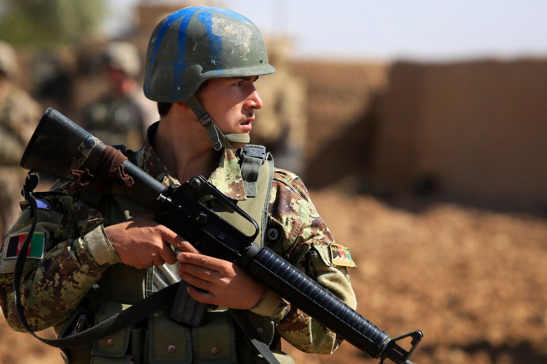 An Afghan national army soldier walks with his M16A2 rifle while ...