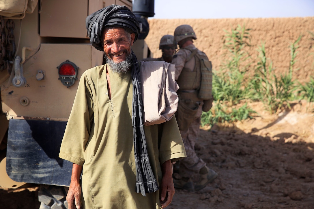 An Afghan Civilian Smiles While Interacting With U.S. Marines ...